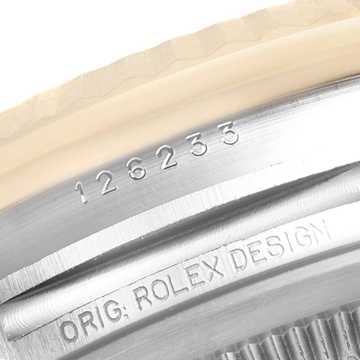 Close-up of the case side of a Rolex Datejust 126233 Men's Steel and Gold (two tone) Champagne Dial 126233 Men's Steel and Gold (two tone) Champagne Dial model, showing its model number and "ORIG. ROLEX DESIGN" engraving.