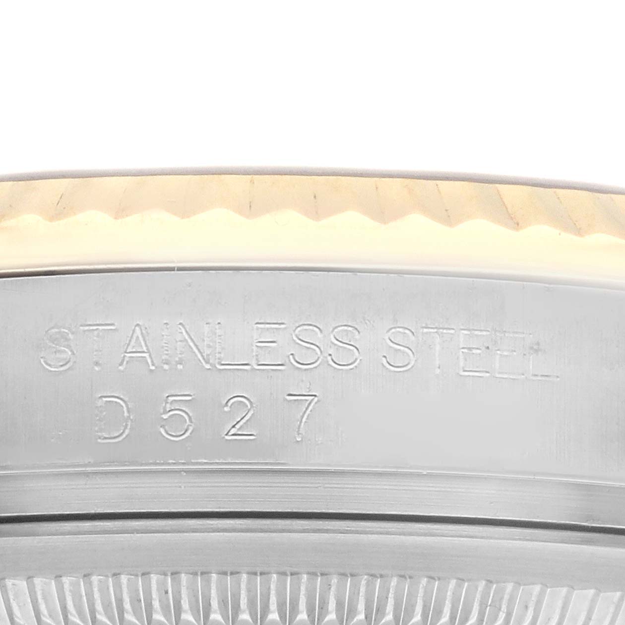 This image shows a close-up of the stainless steel case and fluted bezel of a Rolex Datejust 116233 Men's Steel and Gold (two tone) Mother of Pearl Dial 116233 Men's Steel and Gold (two tone) Mother of Pearl Dial watch.