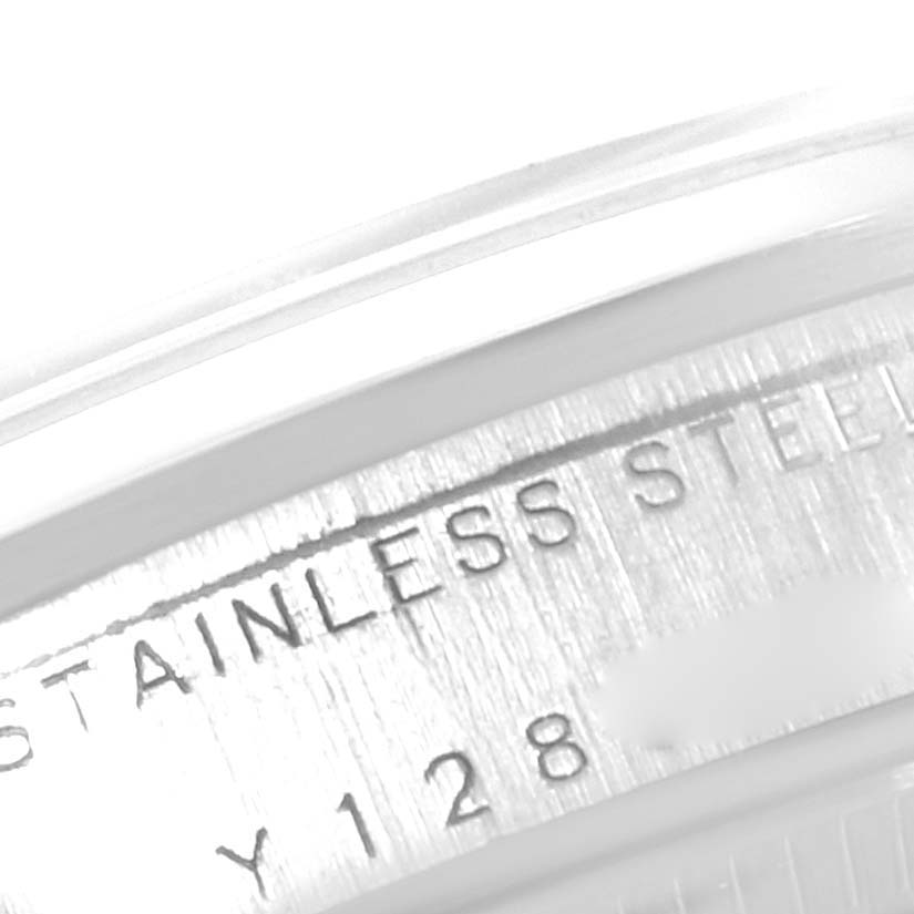 The image shows a close-up of the Rolex Mid-Size 77080 Women
s Stainless Steel White Dial 77080 Women
s Stainless Steel White Dial watch case, highlighting the "STAINLESS STEEL" engraving.