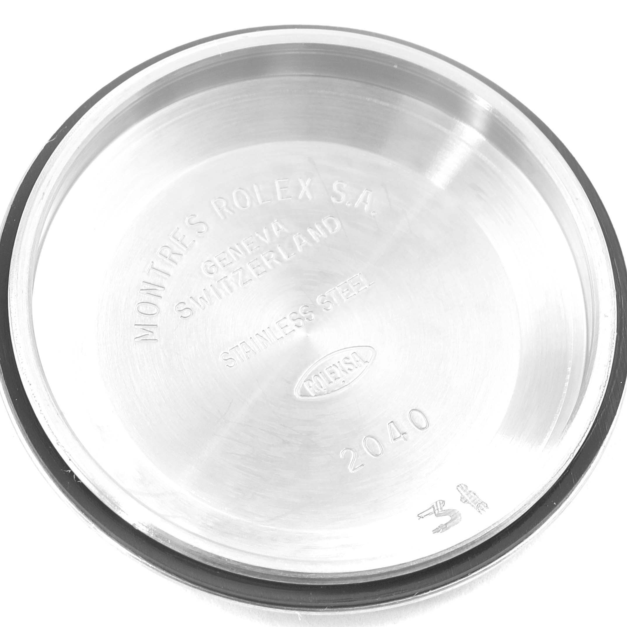 This image shows the inner back case of a mid-size Rolex watch, displaying engravings and stainless steel material.