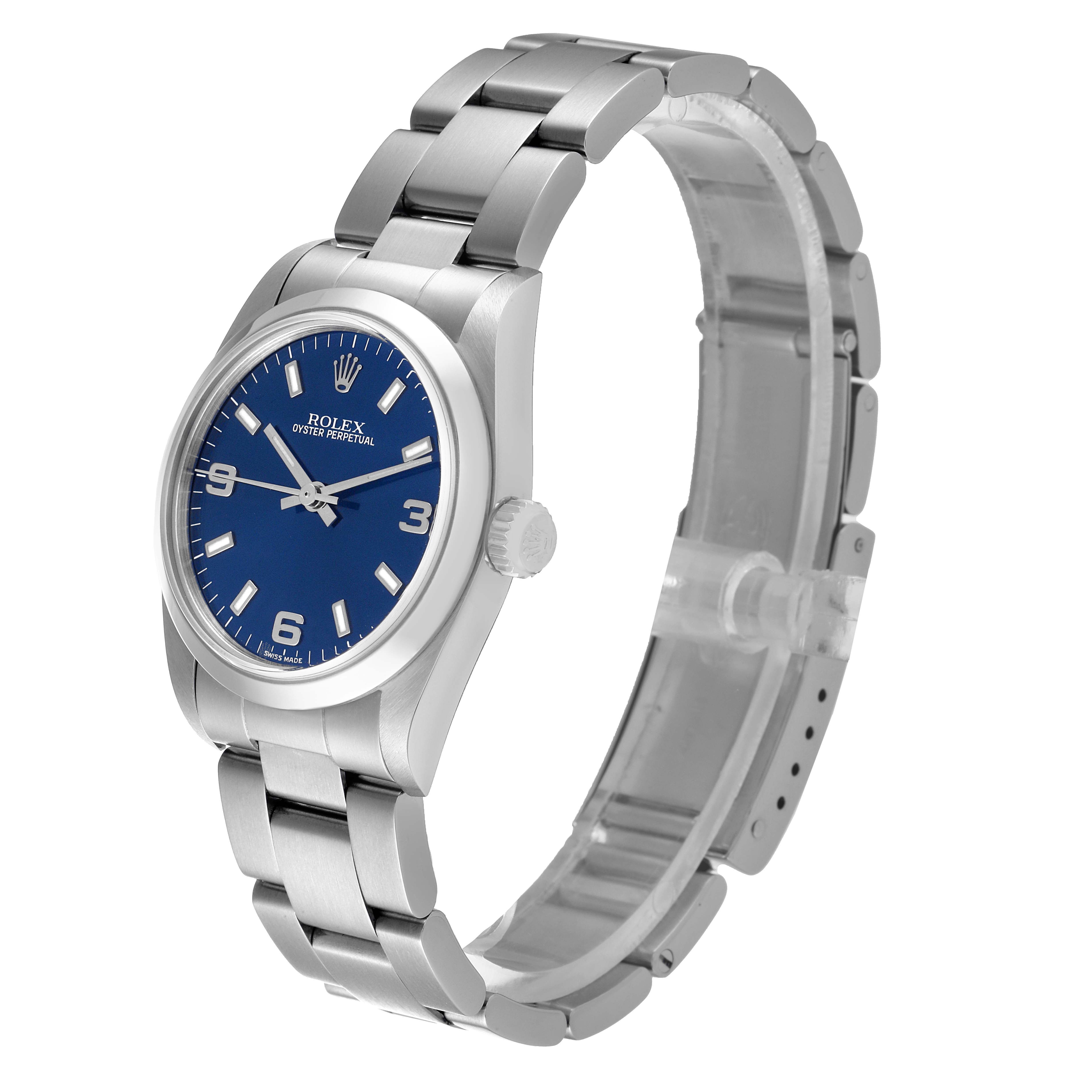 The image shows a Rolex Mid-Size 77080 Women's Stainless Steel Blue Dial 77080 Women's Stainless Steel Blue Dial Oyster Perpetual watch, with a blue dial and stainless steel bracelet, viewed from an angled side perspective.