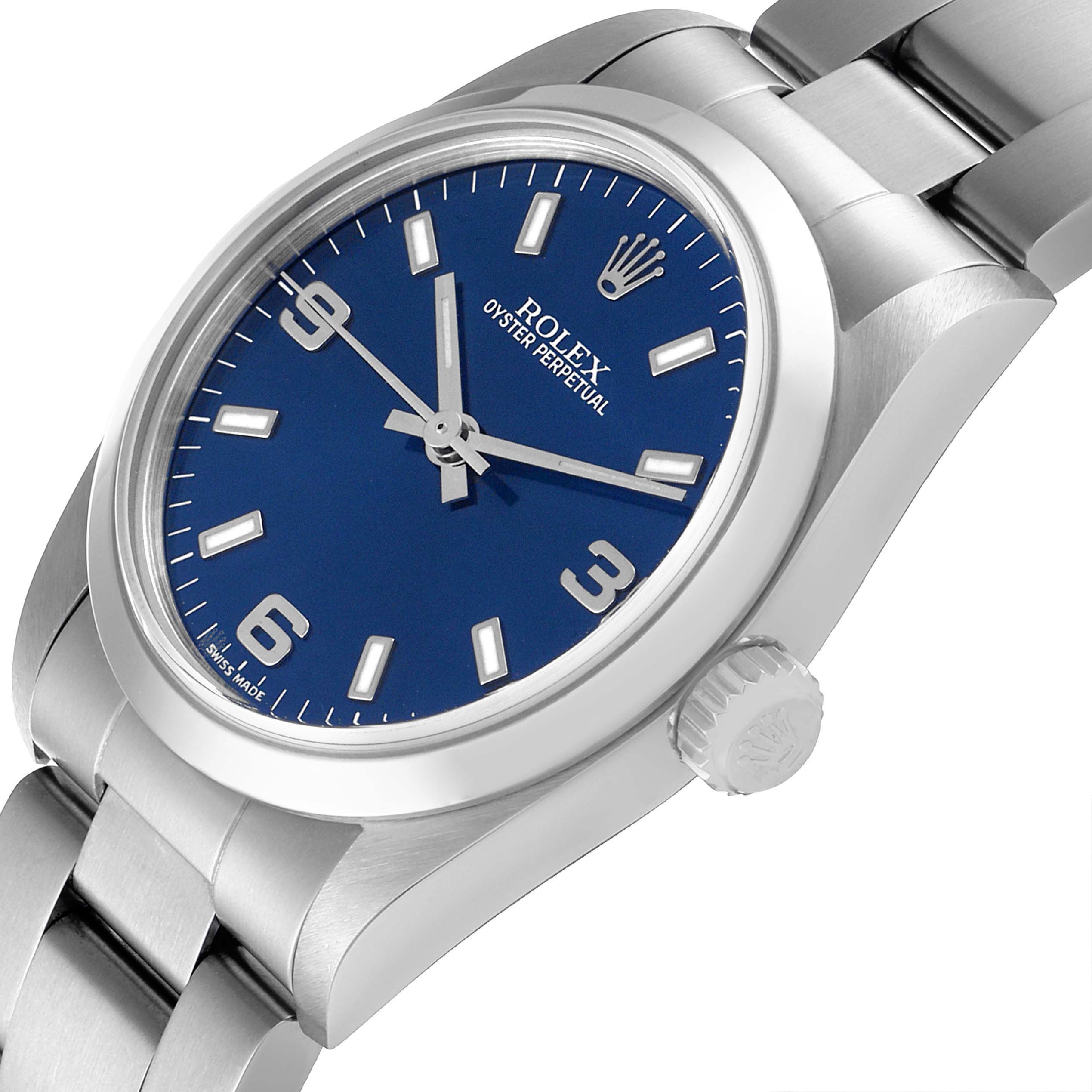 The image shows a Rolex Oyster Perpetual Mid-Size watch angled to display the dial, bezel, crown, and bracelet.