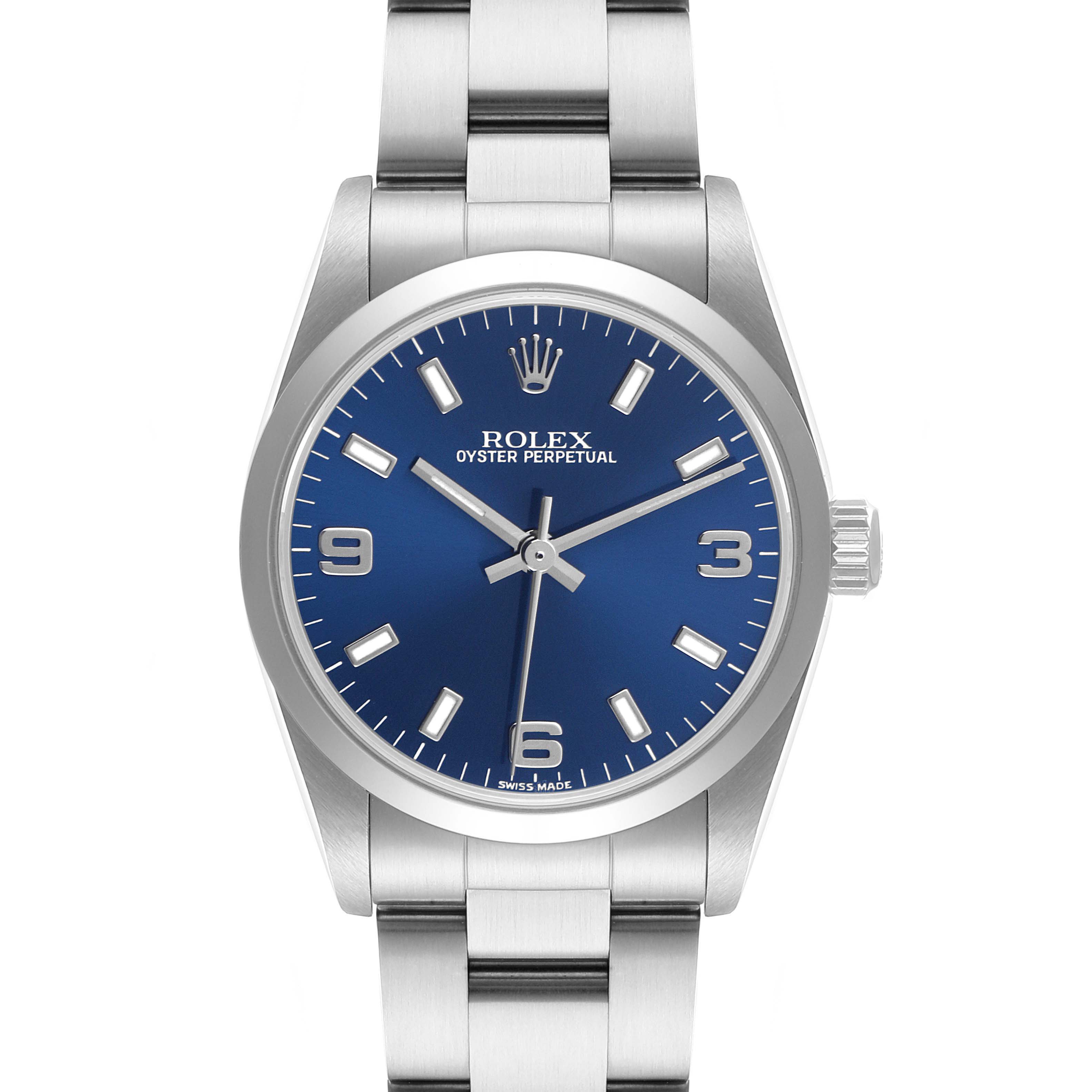 The image shows a front view of a Rolex Oyster Perpetual Mid-Size watch with a blue dial and stainless steel bracelet.