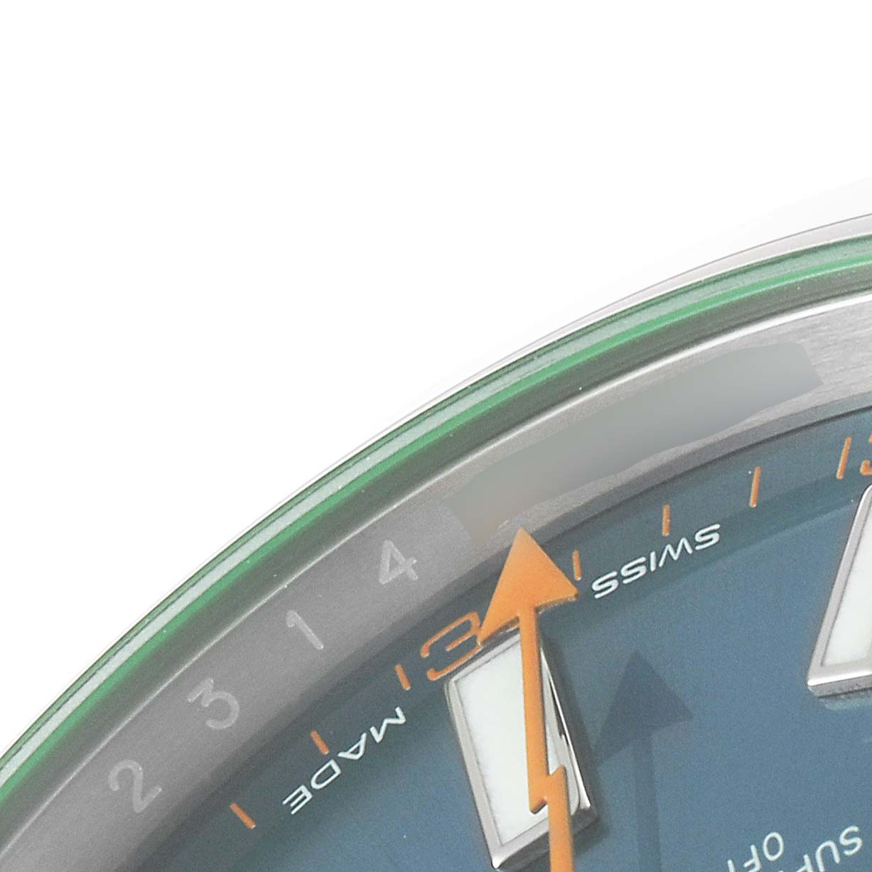 This is a close-up view of the Rolex Milgauss 116400GV Men
s Stainless Steel Blue Dial 116400GV Men
s Stainless Steel Blue Dial watch, showing the minute markers, "Swiss Made" text, and part of the green sapphire crystal.
