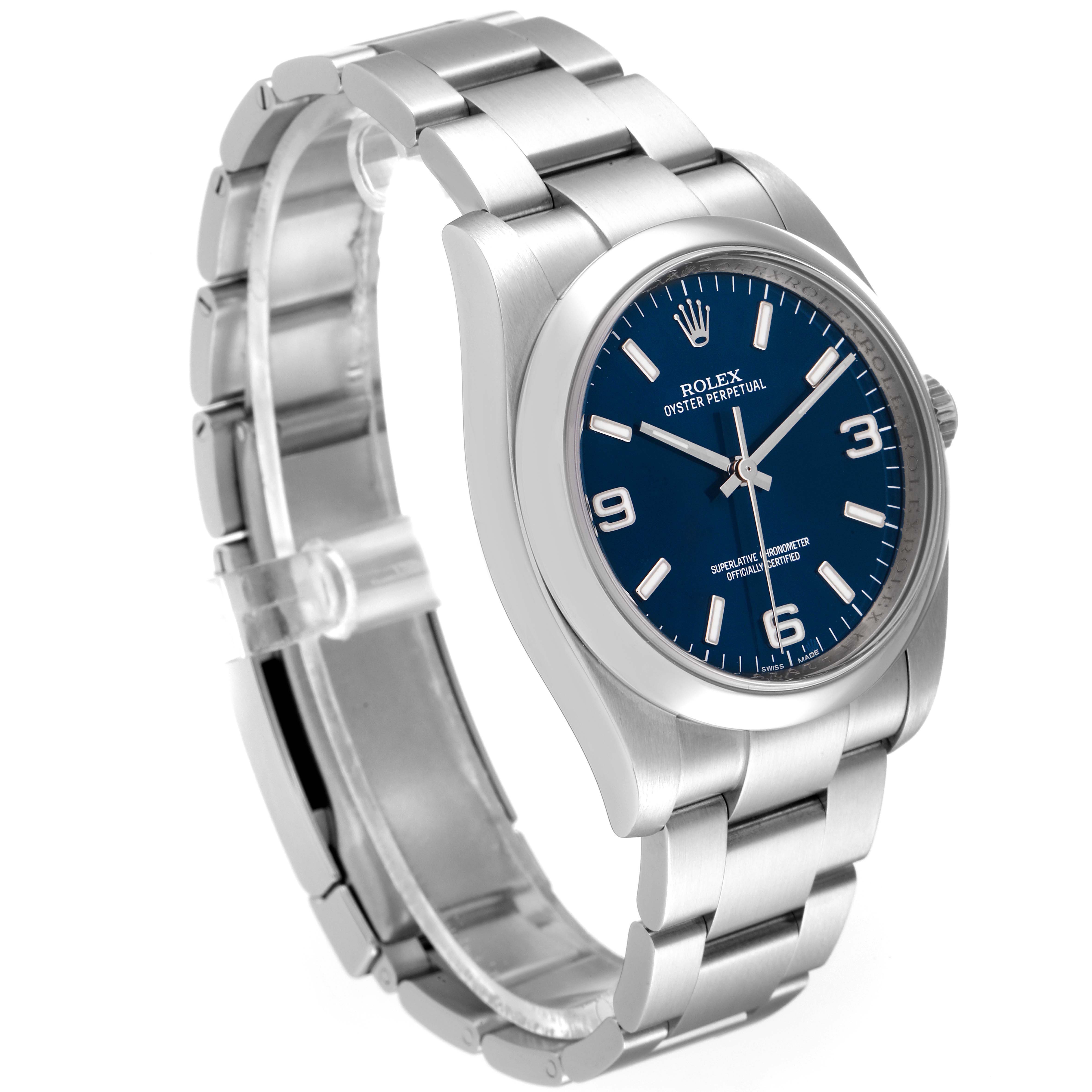 The Rolex Oyster Perpetual 116000 Men's Stainless Steel Blue Dial 116000 Men's Stainless Steel Blue Dial watch is shown from a three-quarter angle, highlighting its blue dial, stainless steel bracelet, and case.