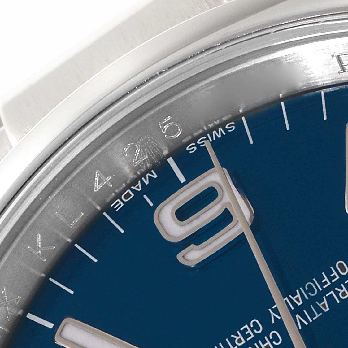 This close-up image of the Rolex Oyster Perpetual 116000 Men's Stainless Steel Blue Dial 116000 Men's Stainless Steel Blue Dial watch shows the dial, partial bezel, and the "Swiss Made" marking.