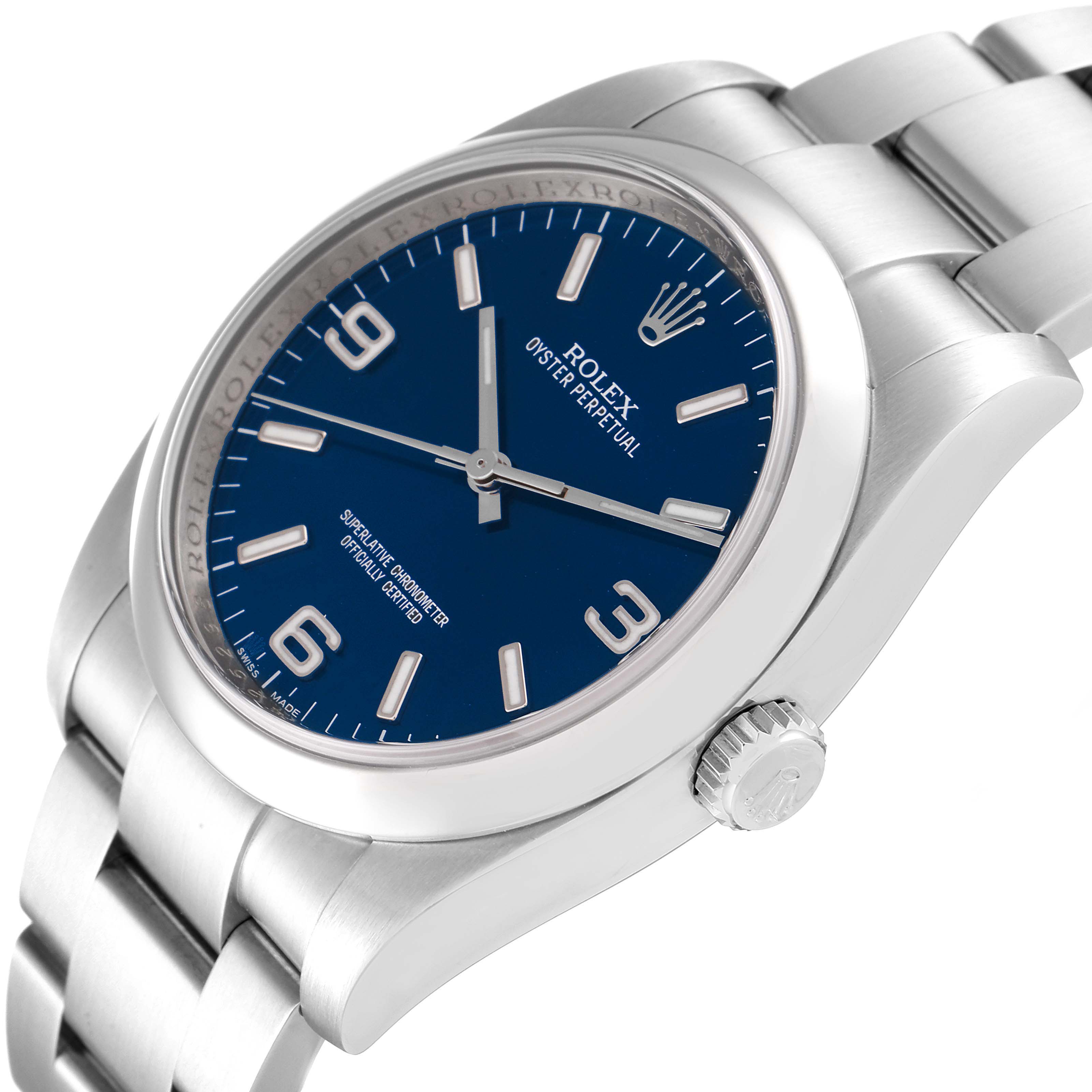 The image shows a side angle of the Rolex Oyster Perpetual 116000 Men's Stainless Steel Blue Dial 116000 Men's Stainless Steel Blue Dial watch highlighting the dial, bracelet, and crown.