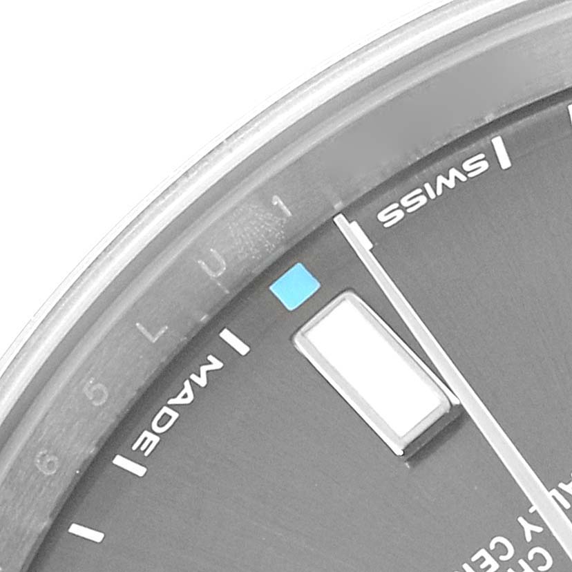 This image shows a close-up of the dial of a Rolex Oyster Perpetual 114300 Men's Stainless Steel Grey Dial 114300 Men's Stainless Steel Grey Dial watch, focusing on the "SWISS MADE" text and a portion of the minute markers.