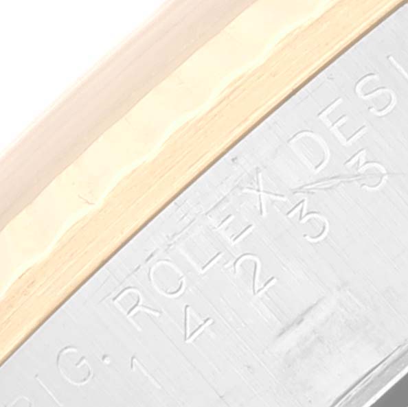 This close-up image shows the engraved "ROLEX" text and numbers on the side of a Rolex Oyster Perpetual 14233 Men's Steel and Gold (two tone) Grey Dial 14233 Men's Steel and Gold (two tone) Grey Dial model watch.