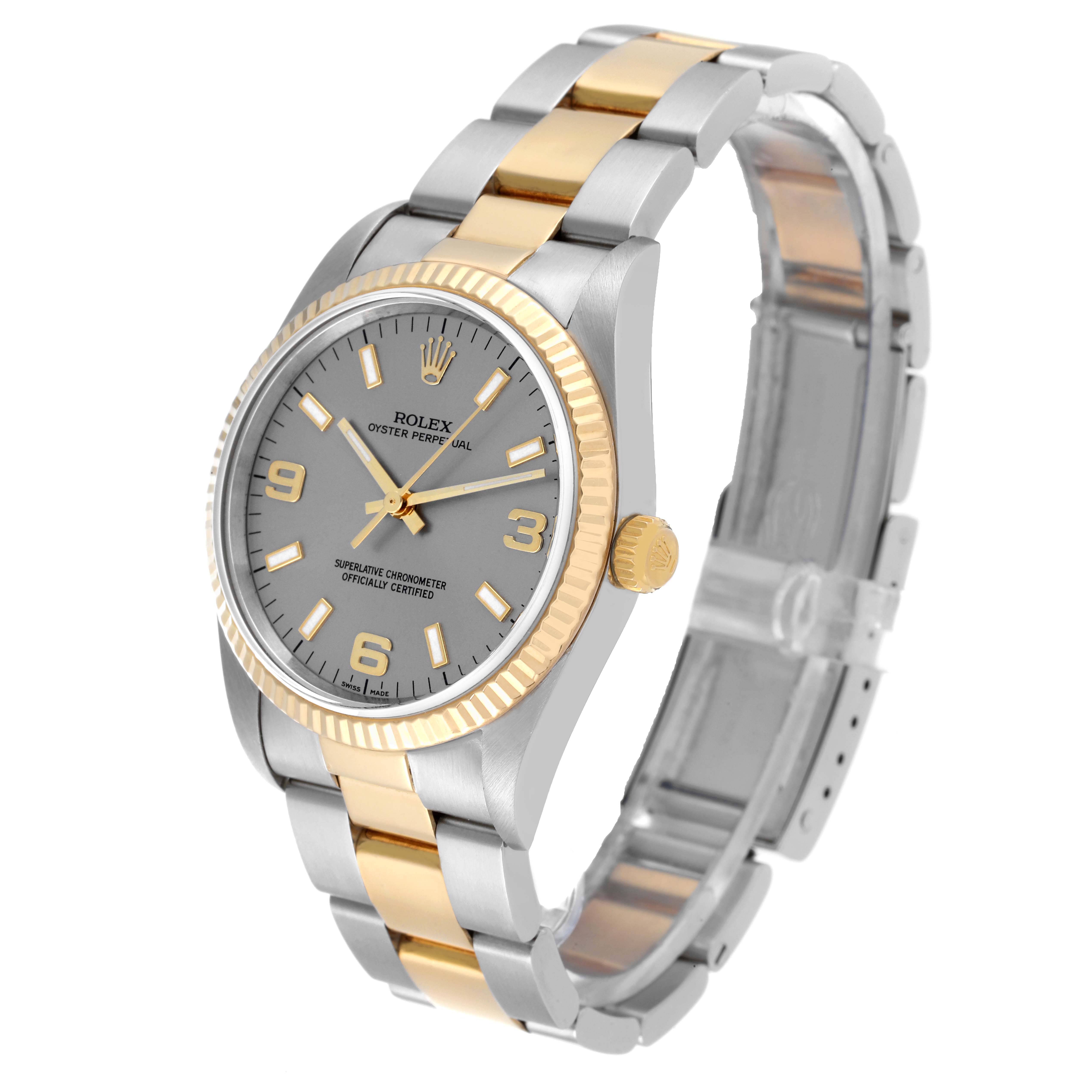 The Rolex Oyster Perpetual 14233 Men's Steel and Gold (two tone) Grey Dial 14233 Men's Steel and Gold (two tone) Grey Dial watch is shown at an angled view, highlighting its gold and silver bracelet, dial, bezel, and crown.
