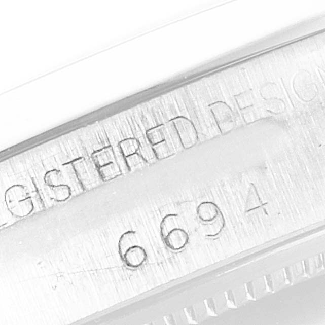 This close-up image shows the engraved model number on the side of a Rolex Vintage Collection 6694 Men's Stainless Steel Black Dial 6694 Men's Stainless Steel Black Dial watch.