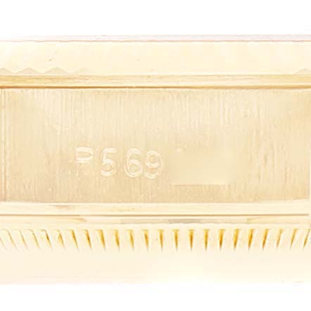 This is a close-up of the Rolex President 69178 Women
s Yellow Gold White Dial 69178 Women
s Yellow Gold White Dial model watch, showing the engraved serial number on the case.