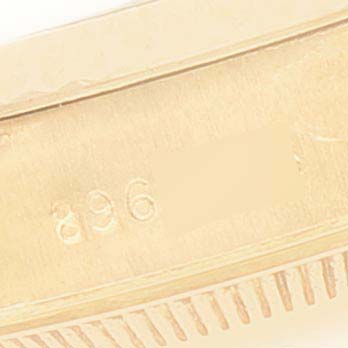 This image shows a close-up of the side casing of a Rolex President 69178 Women
s Yellow Gold Champagne Dial 69178 Women
s Yellow Gold Champagne Dial model watch, focusing on its serial number and fluted bezel.