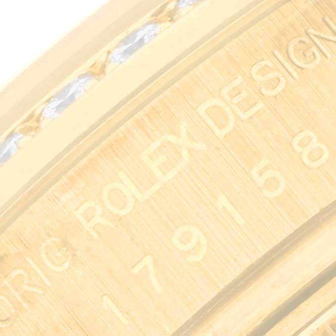 This close-up image shows the side of a Rolex President 179158 Women's Yellow Gold Champagne Dial 179158 Women's Yellow Gold Champagne Dial watch case, highlighting the engraved "ROLEX DESIGN" text.