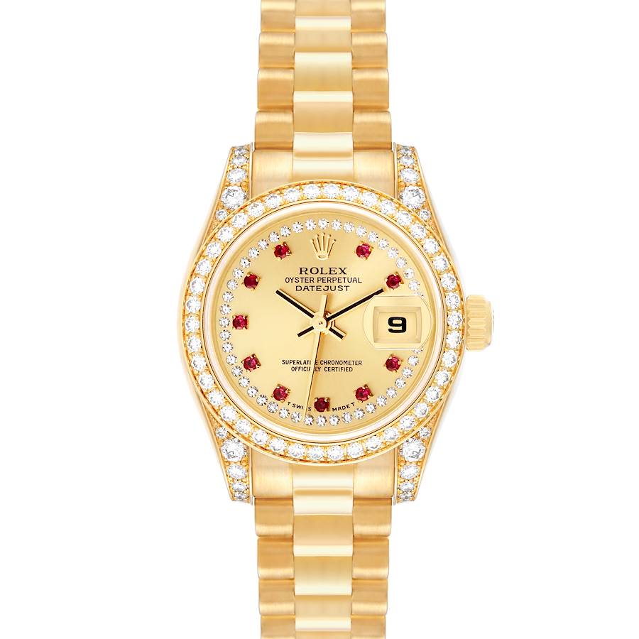 The image shows a top view of a Rolex President model watch featuring a gold band, and ruby indices, with a fluted diamond bezel.