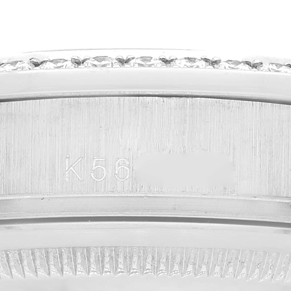 The image shows a close-up of the side of a Rolex President 118346 Men
s Platinum Silver Dial 118346 Men
s Platinum Silver Dial watch bezel and the engraved serial number.