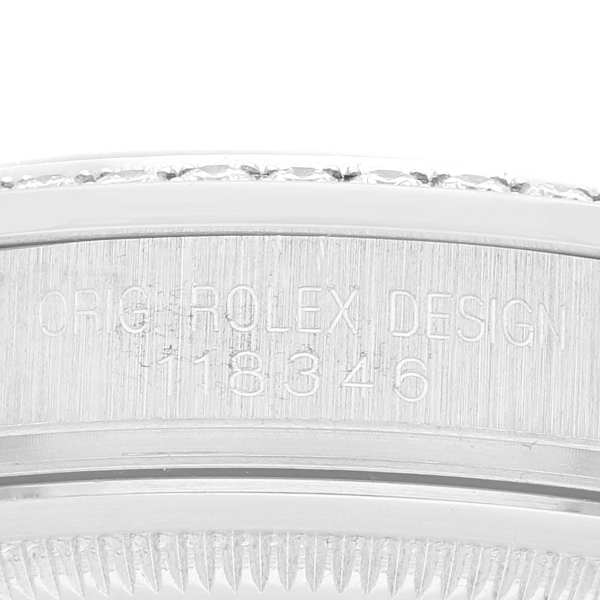 This close-up angle of a Rolex President 118346 Men
s Platinum Silver Dial 118346 Men
s Platinum Silver Dial watch shows the side with the engraved model number "118346" and "ORIG ROLEX DESIGN".