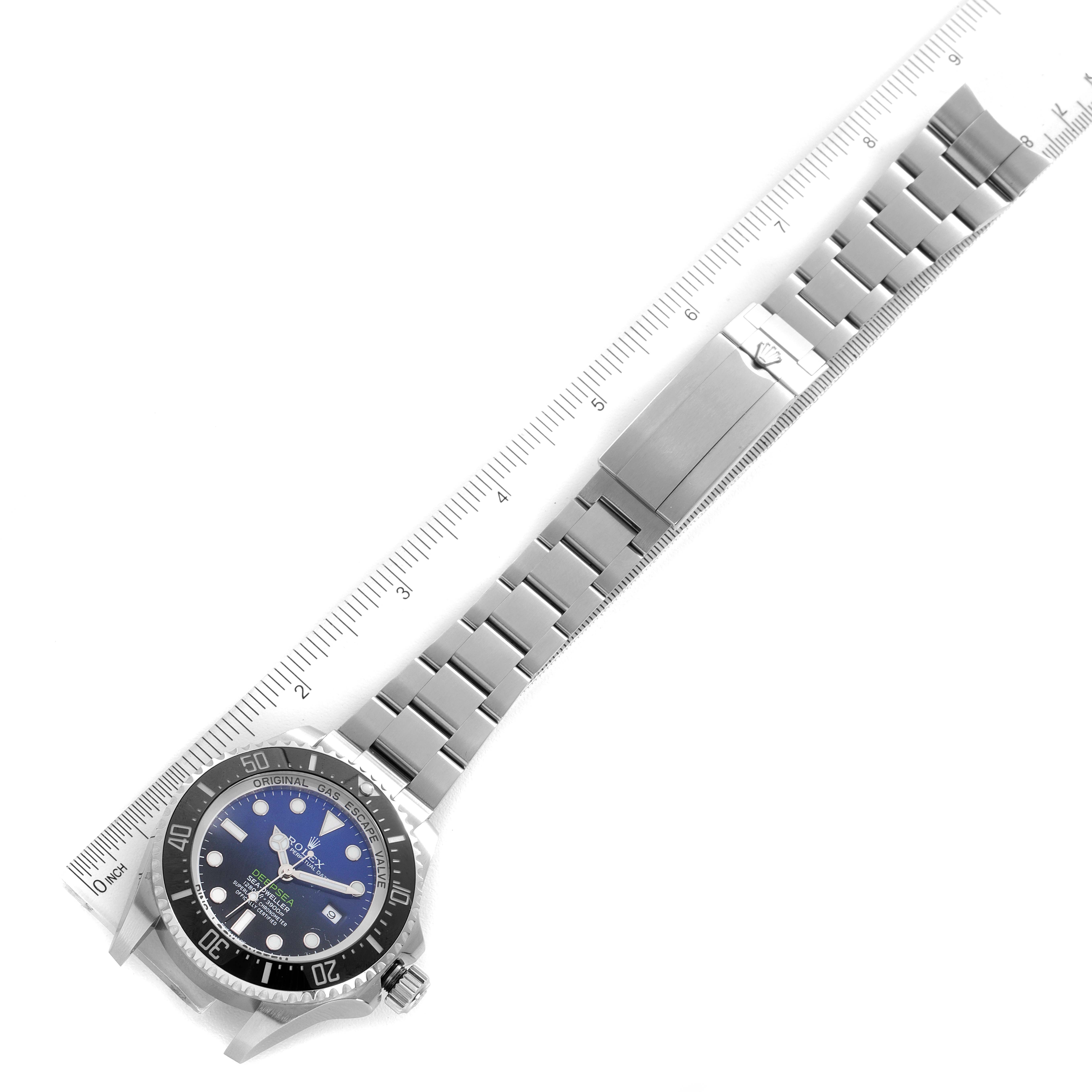 This image shows a top-down angle of a Rolex Sea-Dweller 116660 Men's Stainless Steel Blue Dial 116660 Men's Stainless Steel Blue Dial watch, including the dial, bezel, bracelet, and clasp, with a ruler for scale.