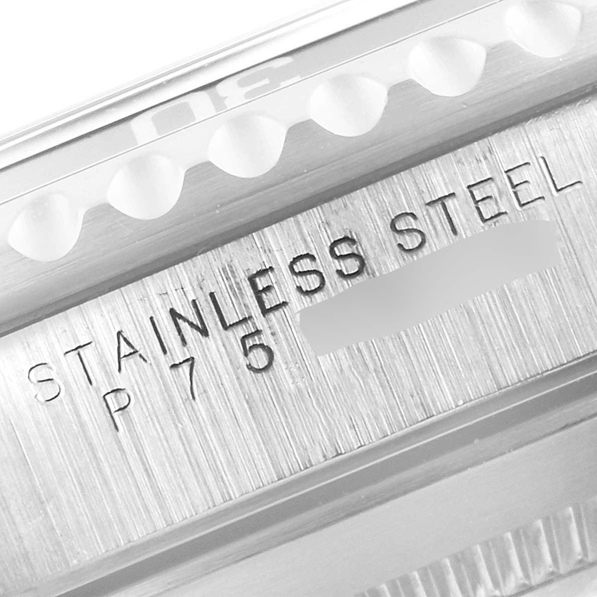 Close-up of the side of a Rolex Submariner 14060 Men
s Stainless Steel Black Dial 14060 Men
s Stainless Steel Black Dial watch, showing part of the bezel and "STAINLESS STEEL" engraving.