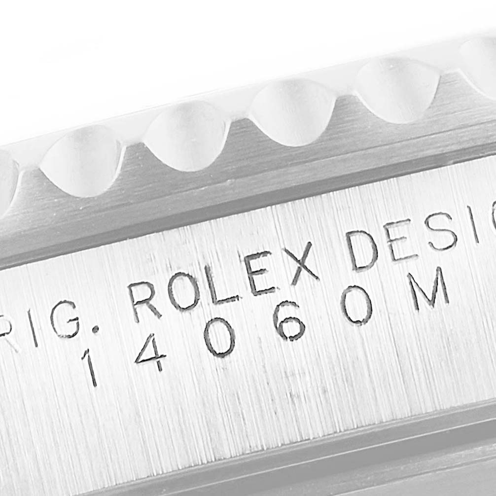 This image shows a close-up of the casing and engraved serial number of a Rolex Submariner 14060 Men's Stainless Steel Black Dial 14060 Men's Stainless Steel Black Dial watch, model 14060M.