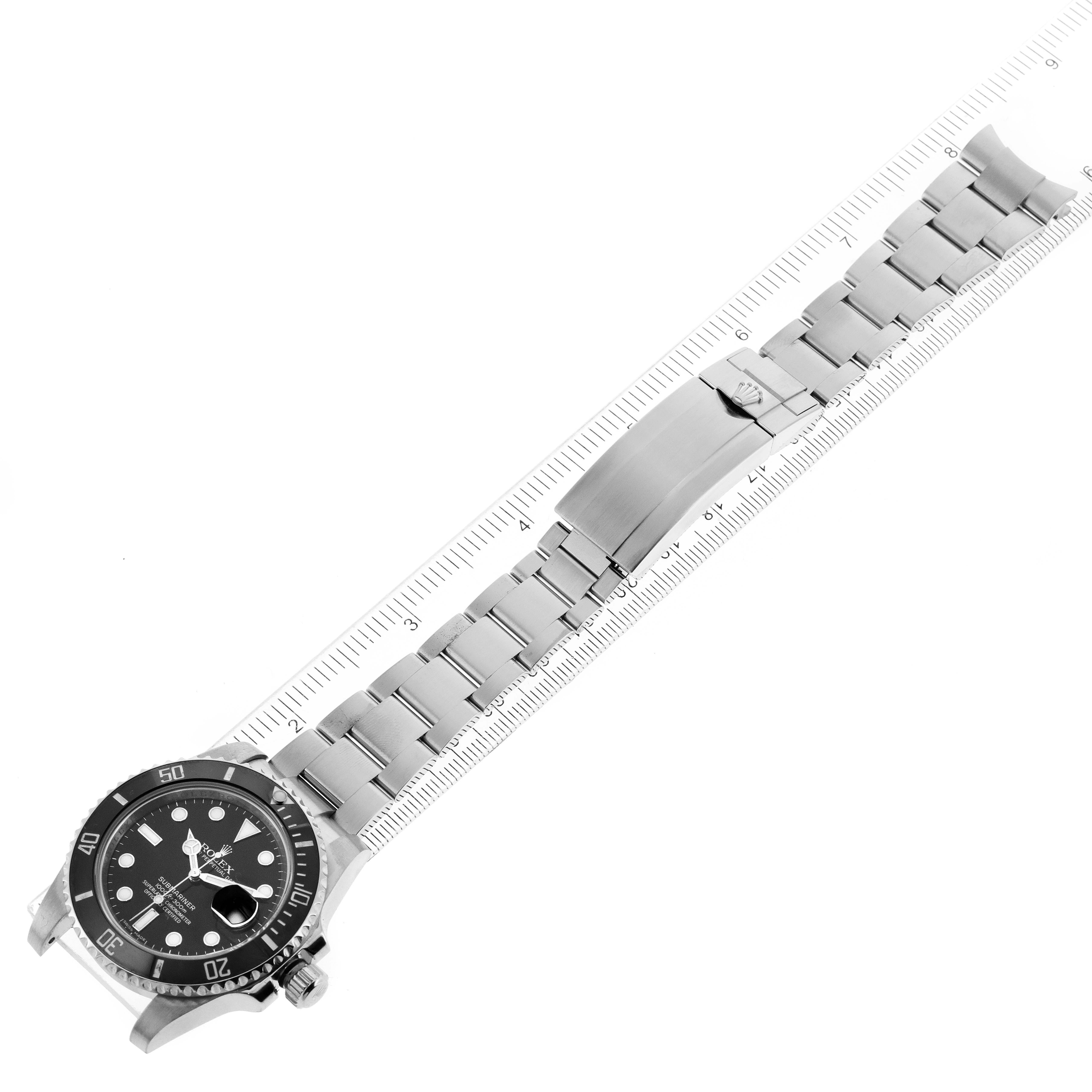 The Rolex Submariner 116610LN Men
s Stainless Steel Black Dial 116610LN Men
s Stainless Steel Black Dial watch is shown flat with a clear view of its face, bezel, bracelet, and clasp, alongside a measuring ruler.
