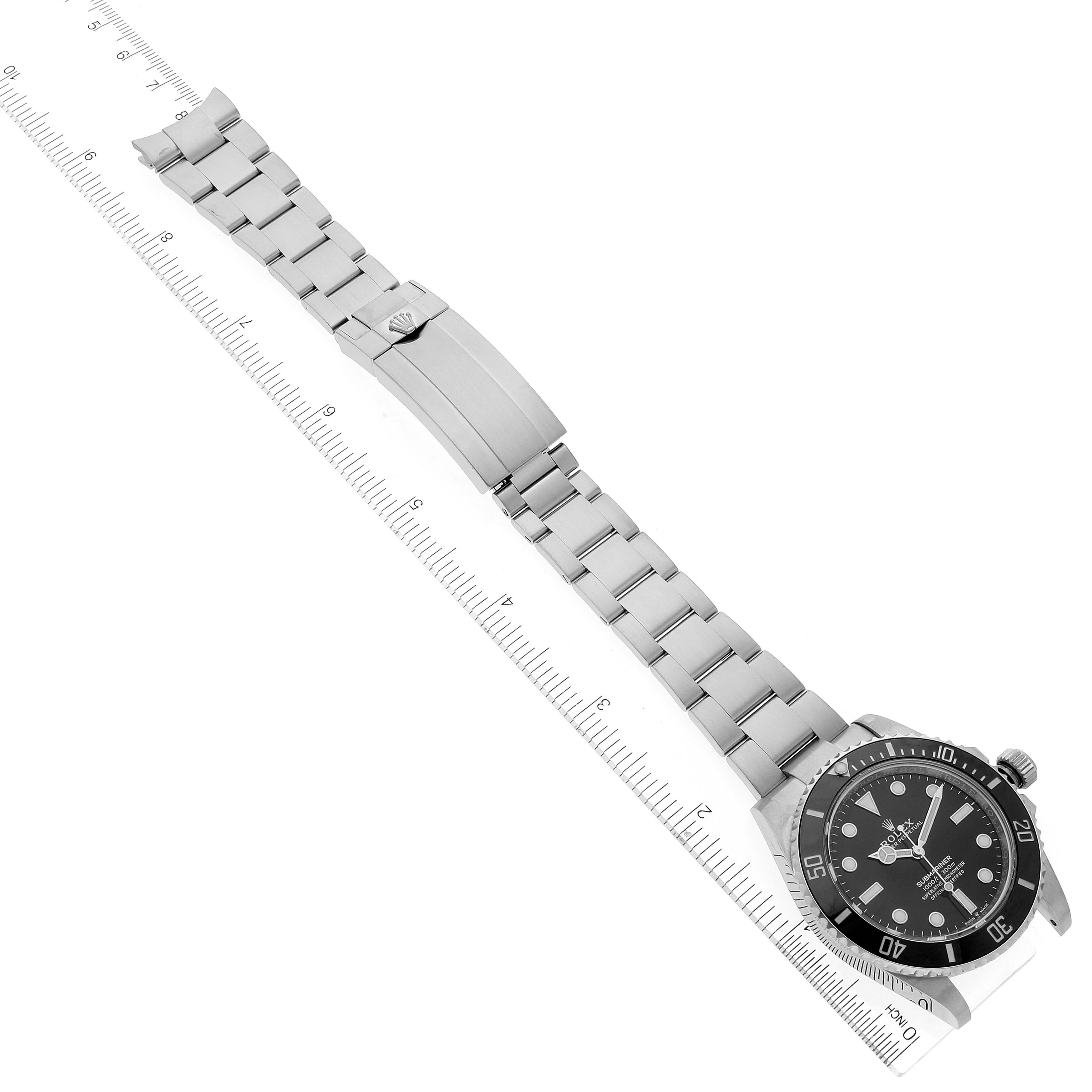 The image shows a Rolex Submariner 124060 Men
s Stainless Steel Black Dial 124060 Men
s Stainless Steel Black Dial watch from a top-down angle, displaying its bracelet, clasp, and dial.