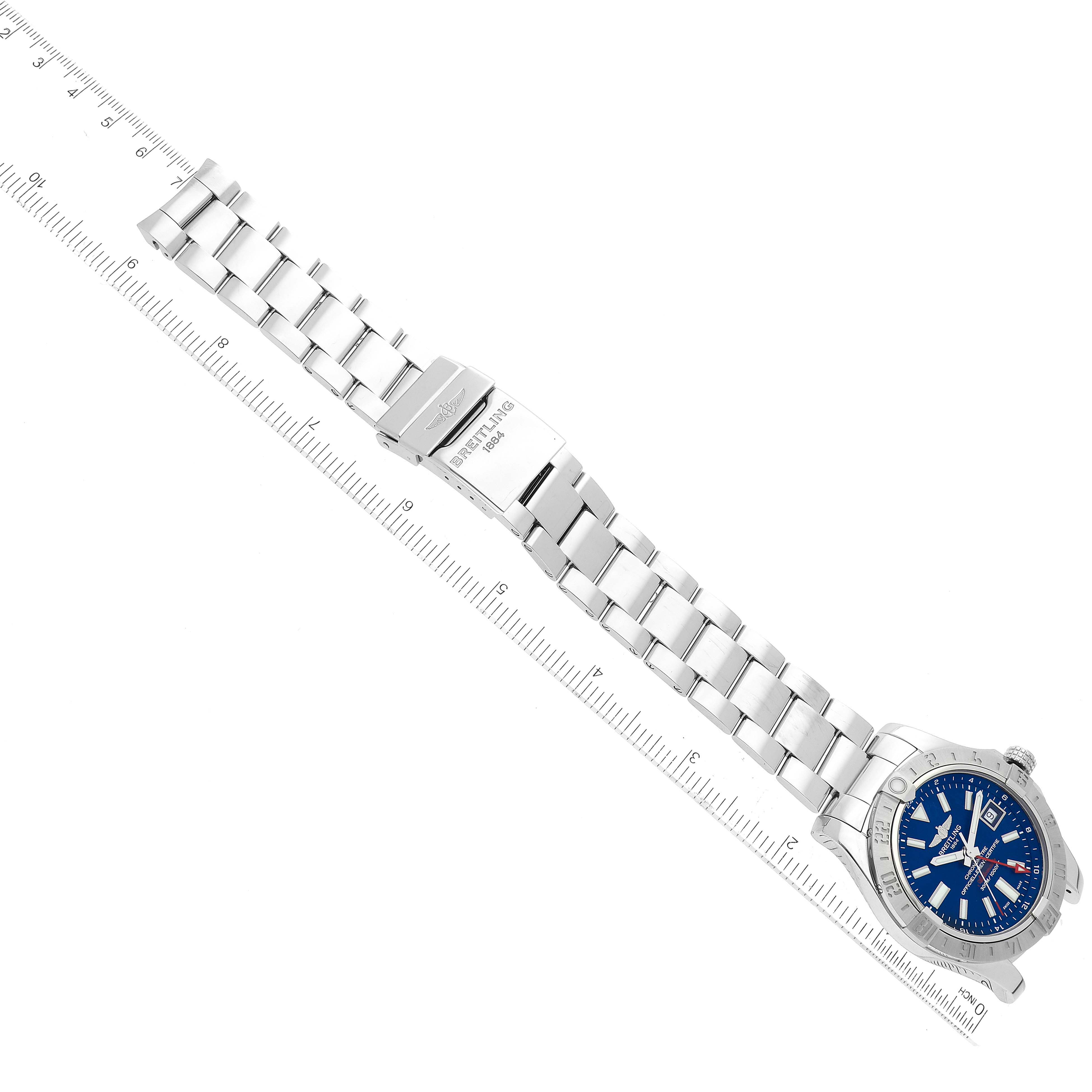 The image shows the entire Breitling Avenger A3239011/C872 Men's Stainless Steel Blue Dial A3239011/C872 Men's Stainless Steel Blue Dial watch laid flat, displaying the face, bezel, bracelet, and clasp with a ruler indicating scale.