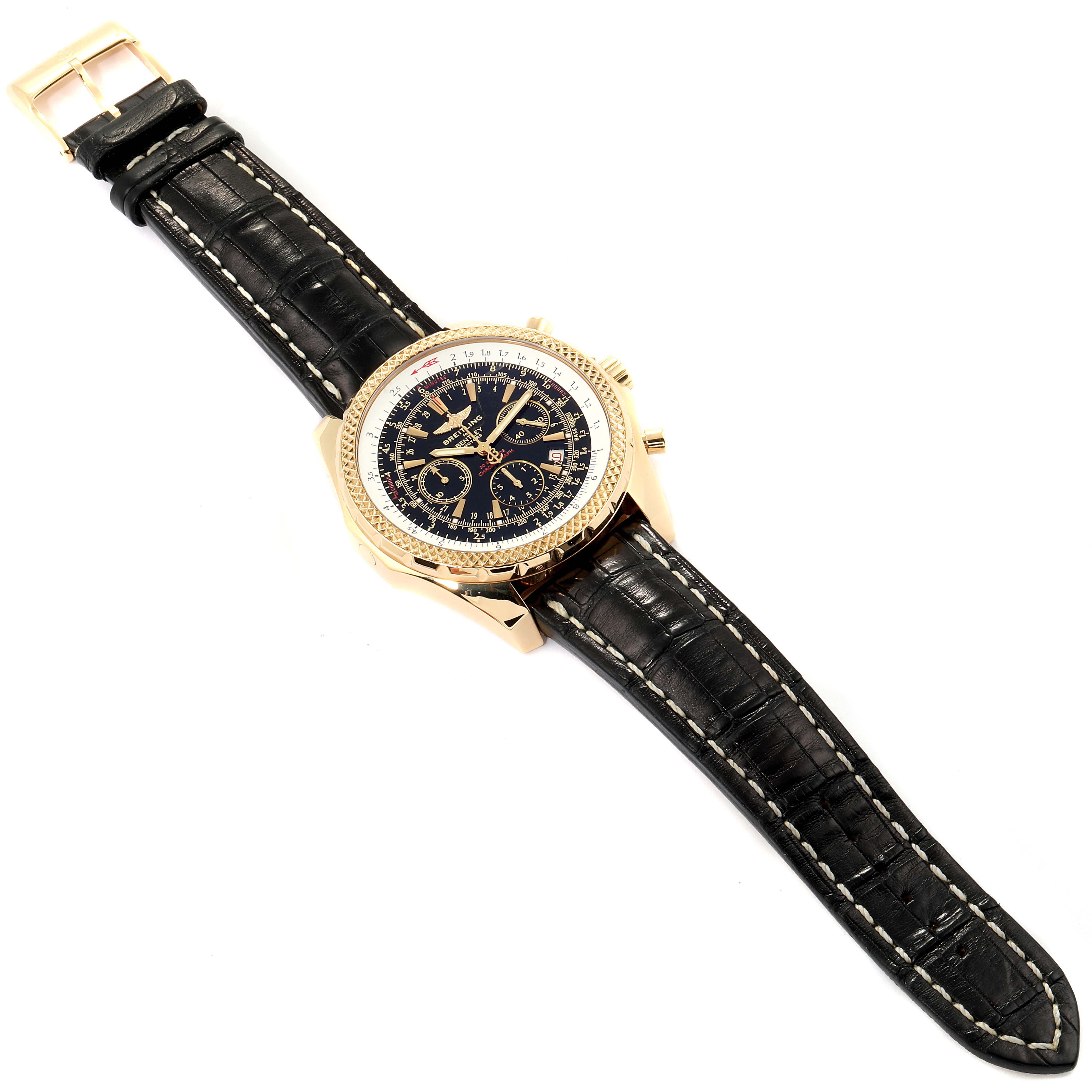 The Breitling Bentley K25362  Men's Yellow Gold Black Dial K25362  Men's Yellow Gold Black Dial watch is shown from an angled top-down view, displaying its dial, bezel, and leather strap.