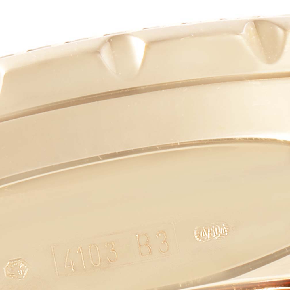 This is a close-up of the Breitling Bentley K25362  Men's Yellow Gold Black Dial K25362  Men's Yellow Gold Black Dial model's case side, showing the model number "4103 B3" engraved.