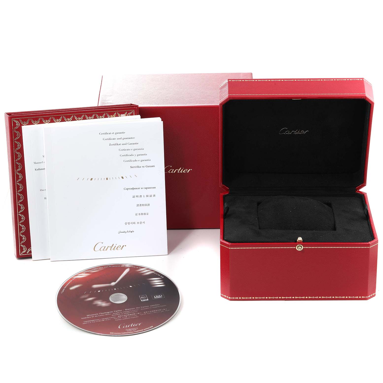 The image shows a Calibre de Cartier model by Cartier box, manuals, and a CD, arranged neatly at eye level.