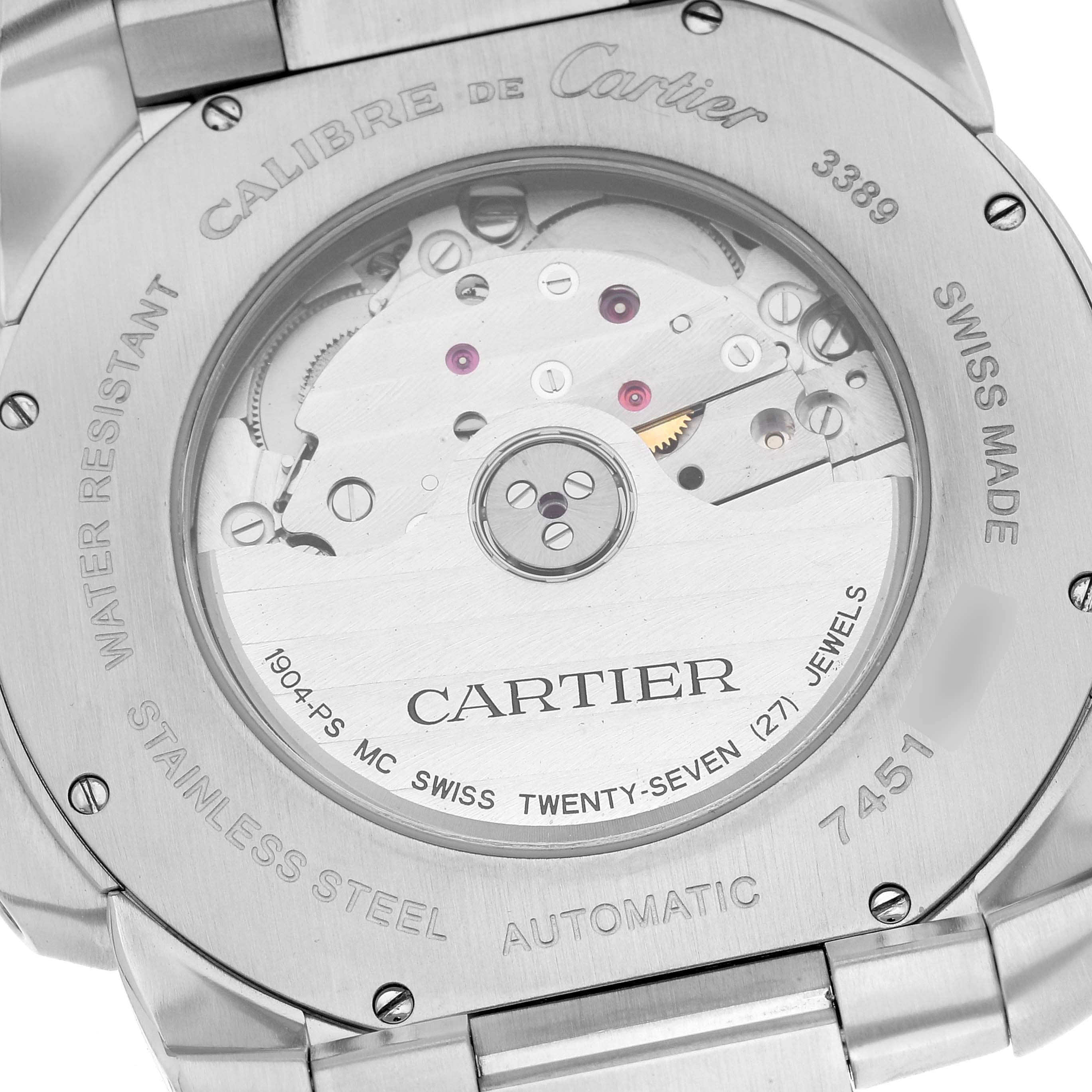 The image shows the case back and internal mechanisms of the Calibre de Cartier watch by Cartier.