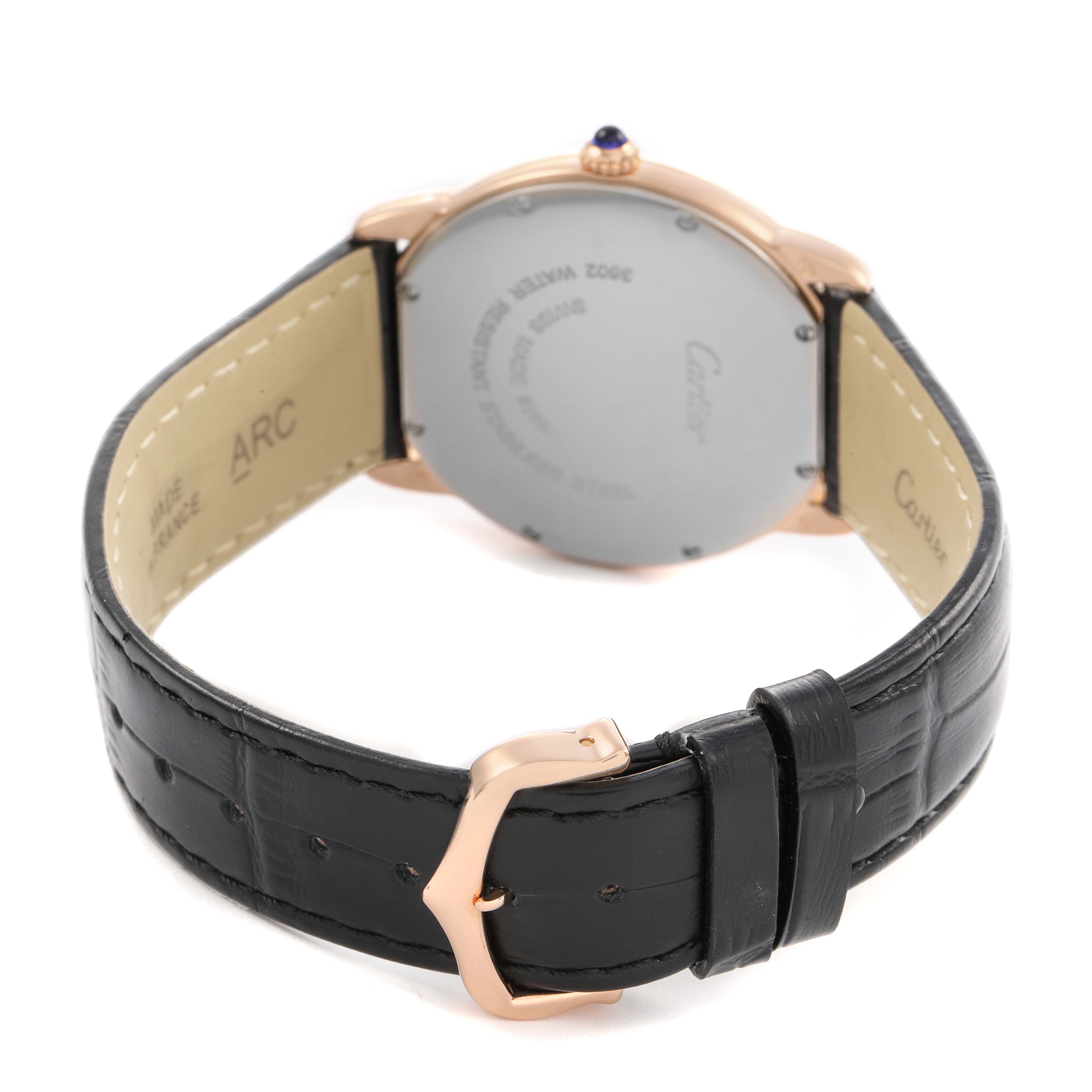 The Ronde model by Cartier is shown from the back, highlighting the case back, black leather strap, and rose gold buckle.