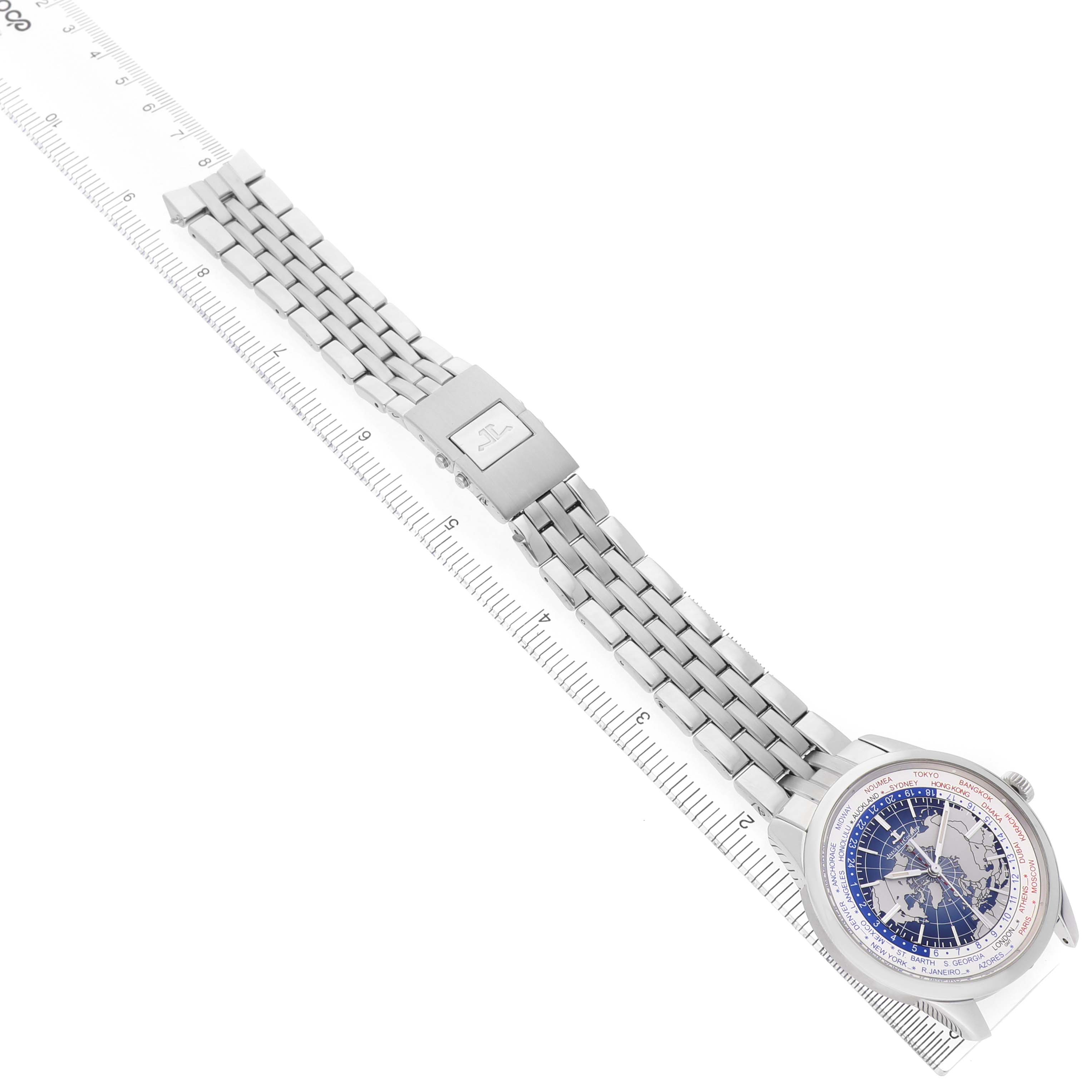The Jaeger LeCoultre Geophysic Q8108420 Men's Stainless Steel Blue Dial watch is shown at an angled top view, highlighting the face, bracelet, and clasp against a ruler.