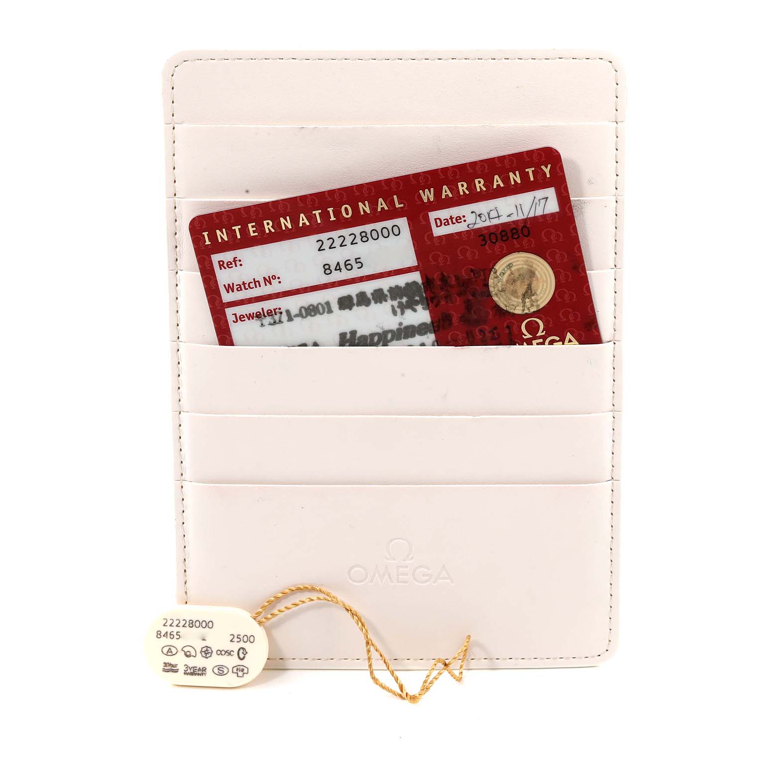 The image shows the International Warranty card and hang tag for an Omega Seamaster 2222.80.00 Men's Stainless Steel Blue Dial 2222.80.00 Men's Stainless Steel Blue Dial watch, placed in a white Omega cardholder.