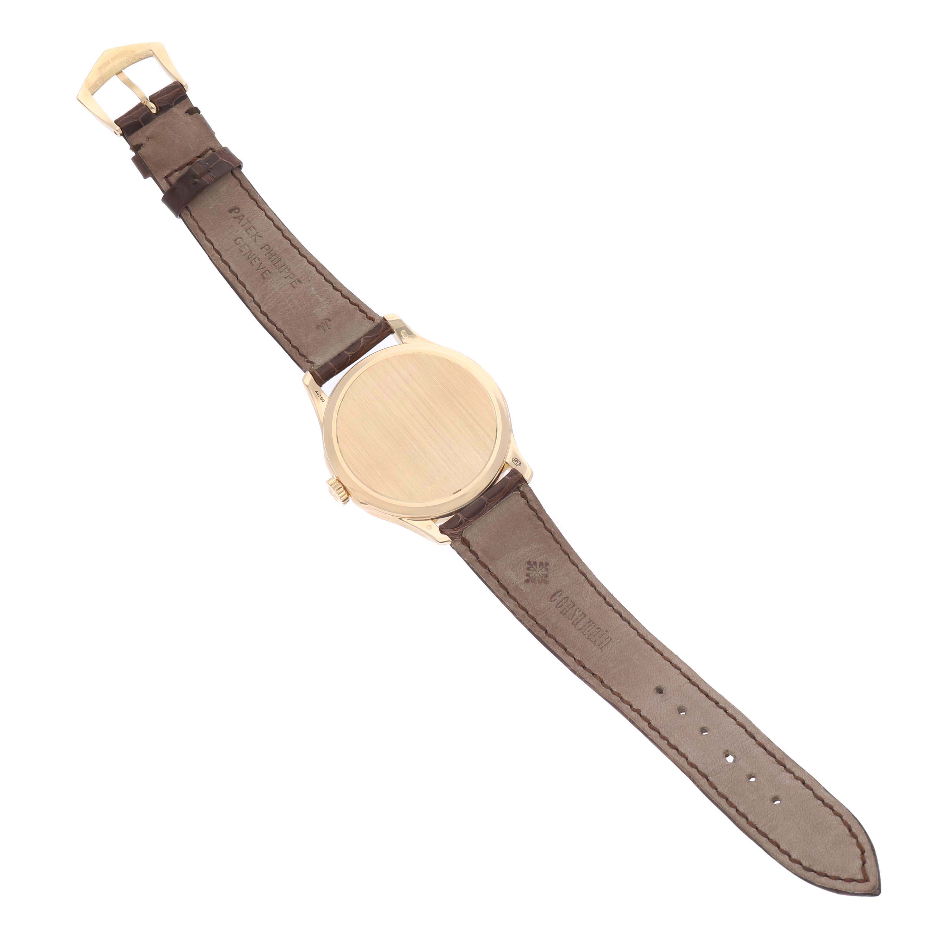 The image shows the back of a Patek Philippe Calatrava 5227J Men's Yellow Gold White Dial watch at a slight angle, highlighting the watch case and leather strap.