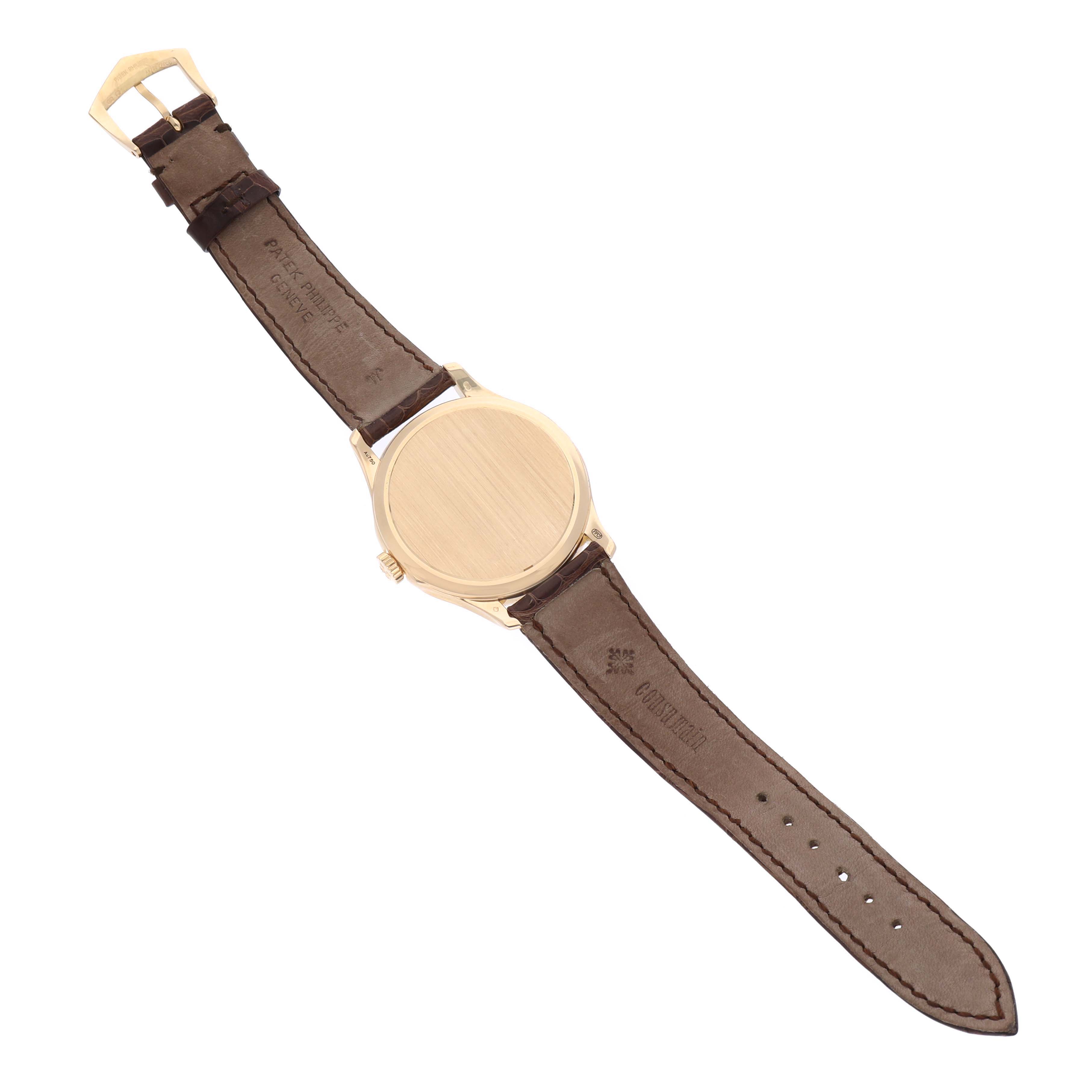 This image shows the back view of a Patek Philippe Calatrava 5227J Men's Yellow Gold White Dial 5227J Men's Yellow Gold White Dial watch, focusing on the case back, crown, and leather straps.