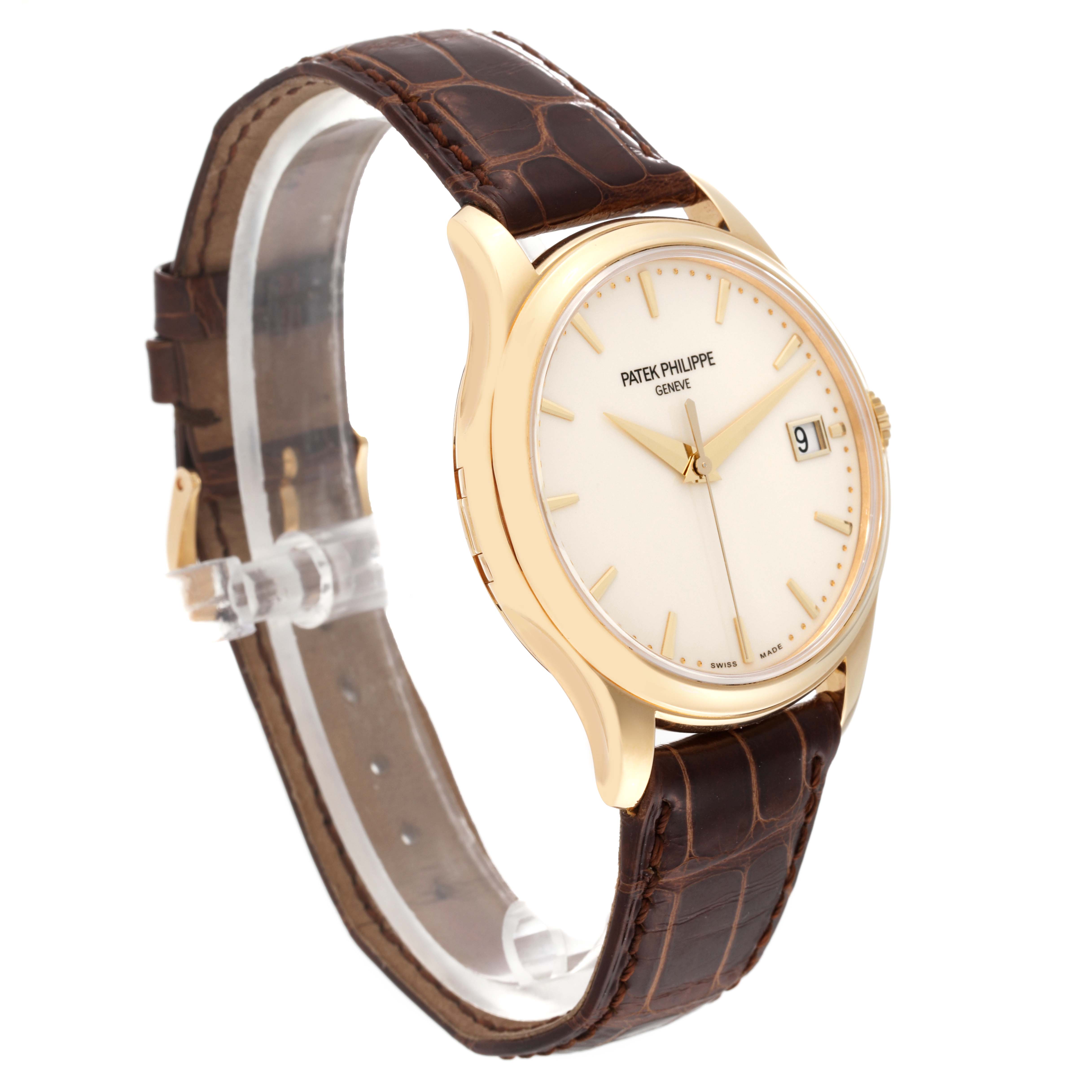 The Patek Philippe Calatrava 5227J Men's Yellow Gold White Dial 5227J Men's Yellow Gold White Dial watch is shown at a slight angle, highlighting the gold case, white dial, brown leather strap, and date display.