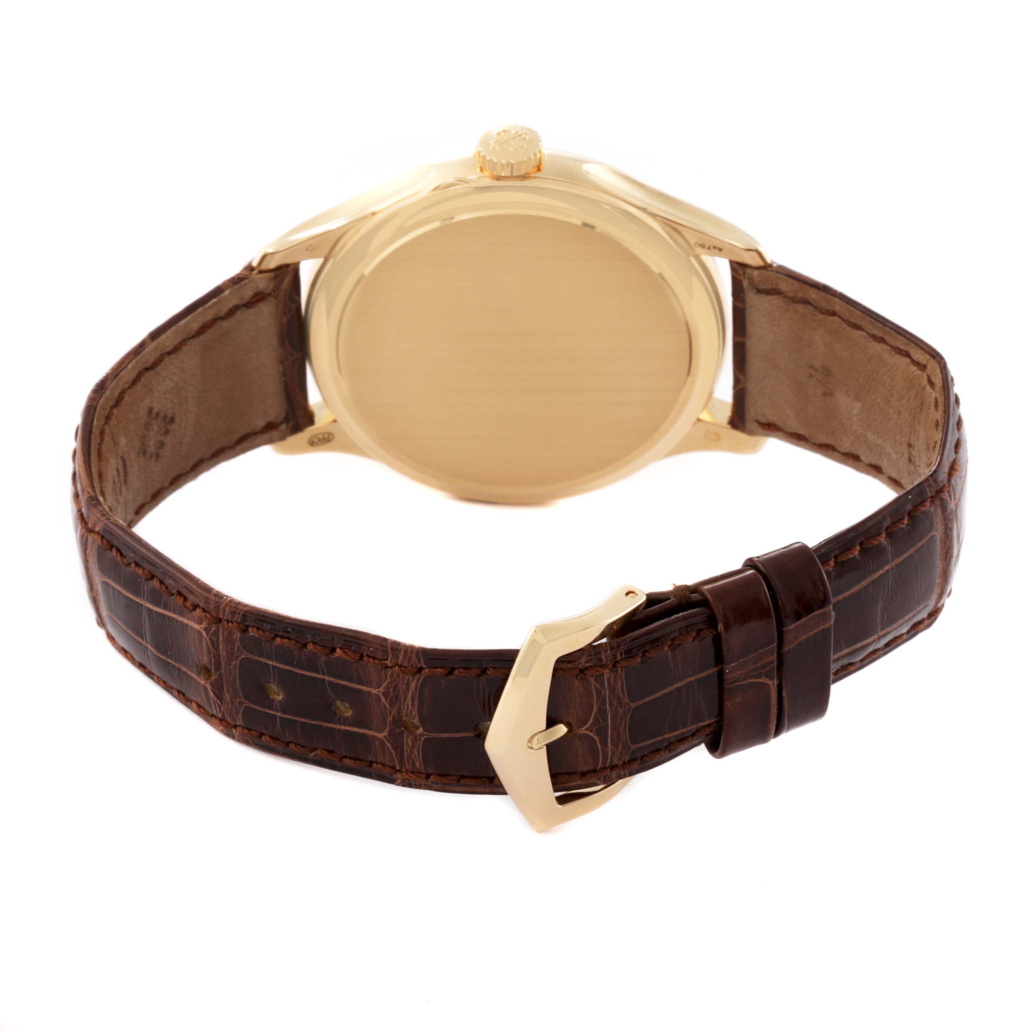 The image shows the back view of a Patek Philippe Calatrava 5227J Men's Yellow Gold White Dial 5227J Men's Yellow Gold White Dial watch with its leather strap and clasp.