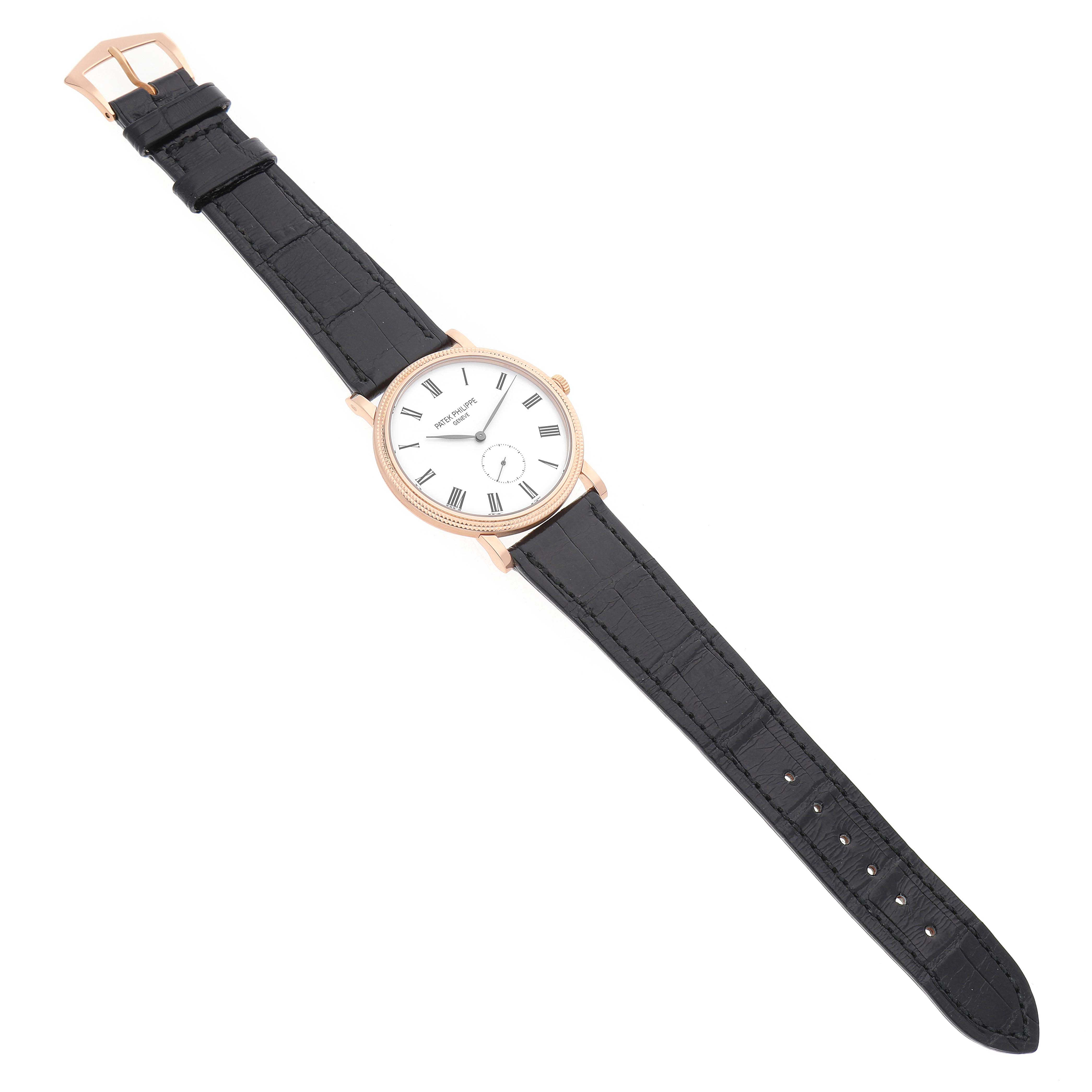 The Patek Philippe Calatrava 5119 5119R Men's Rose Gold White Dial watch is shown from a top-down angle, displaying the dial, leather strap, and buckle.