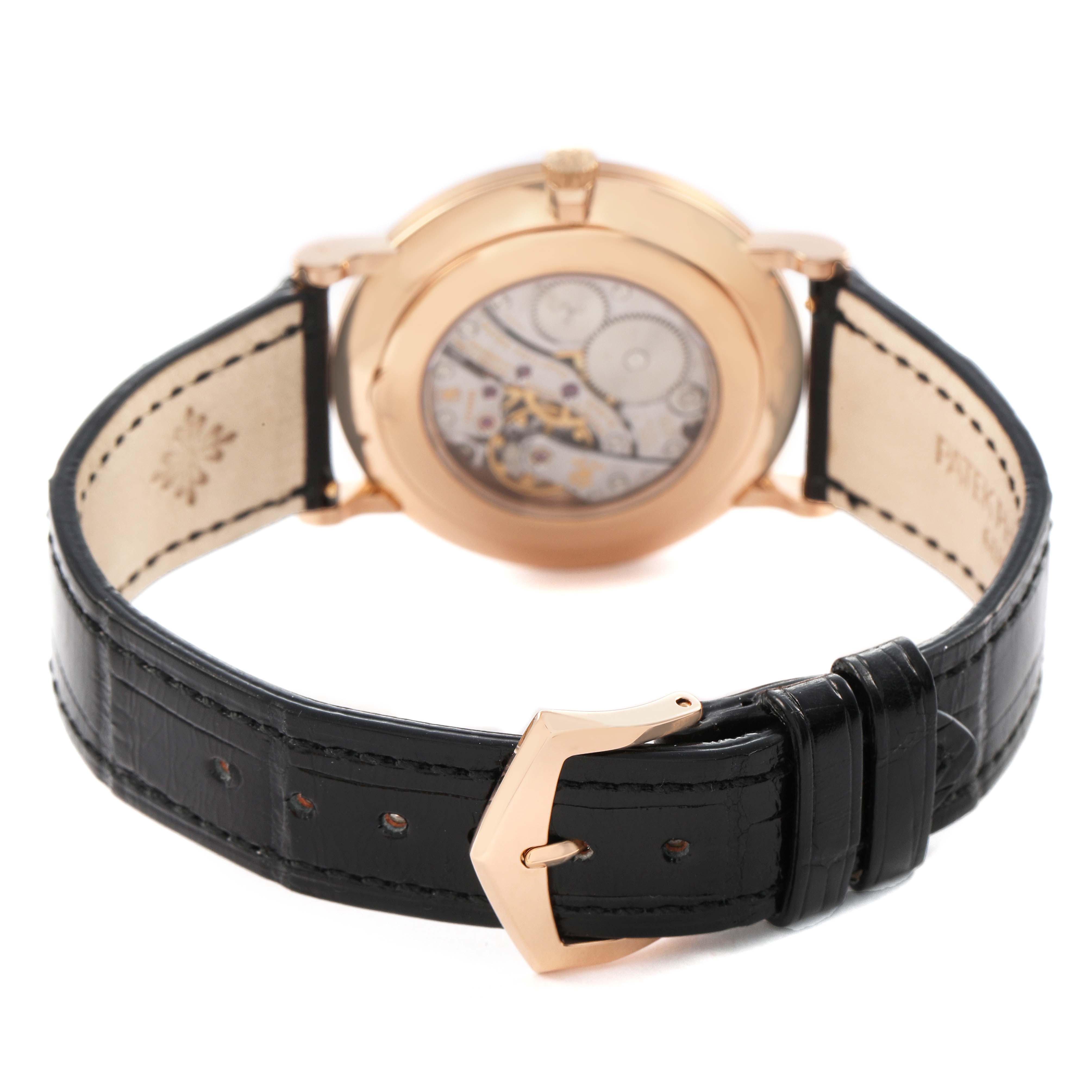 The image shows the back view of a Patek Philippe Calatrava 5119 5119R Men's Rose Gold White Dial watch, highlighting the exposed movement and black leather strap with a gold buckle.