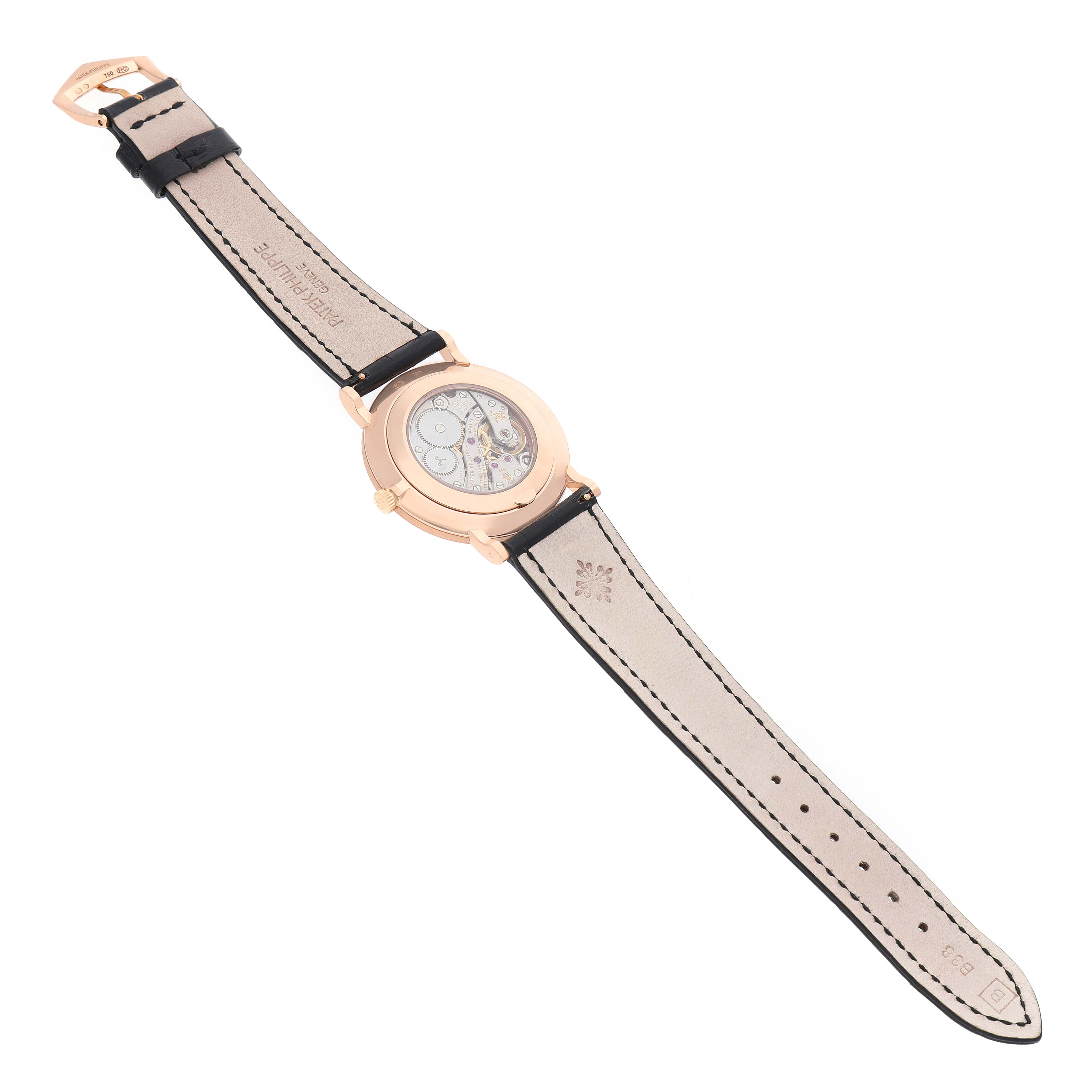 The Patek Philippe Calatrava 5119 5119R Men's Rose Gold White Dial watch is shown from a top view, displaying the underside of the strap and the watch's back.