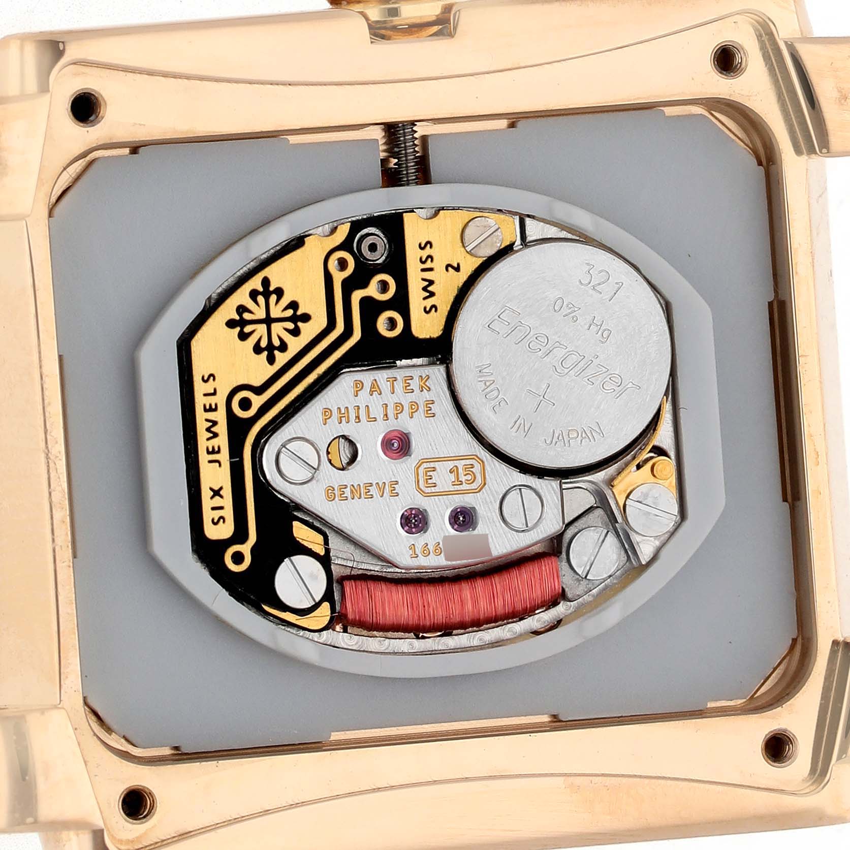 The image shows the back of a Patek Philippe Twenty-4 4910/11R-011 Women's Rose Gold Silver Dial watch, highlighting its intricate movement and battery.