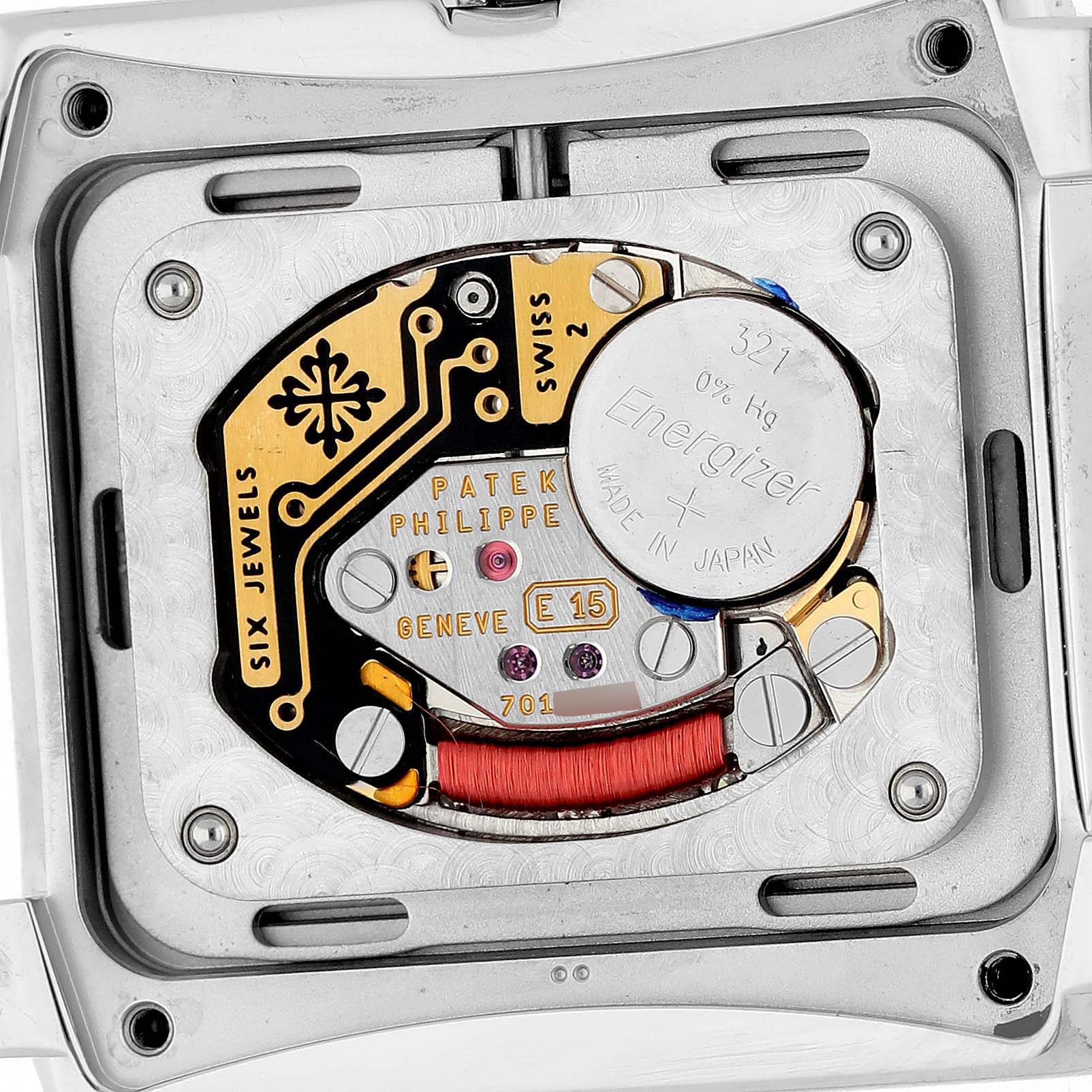 The image shows the back view of the Patek Philippe Twenty-4 4910/10A-012 Women's Stainless Steel Blue Dial, focusing on its battery and intricate movement details.
