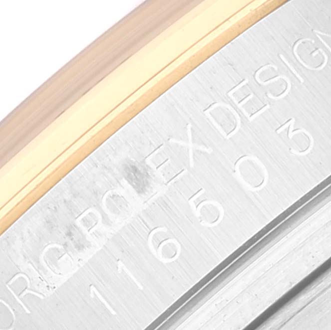This is a close-up angle showing the engraved design and serial number on the case of a Rolex Daytona 116503 Men's Steel and Gold (two tone) White Dial 116503 Men's Steel and Gold (two tone) White Dial watch.
