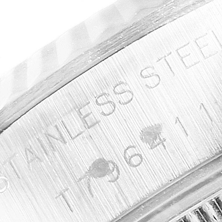 The image shows a close-up of the brushed stainless steel case back of a Rolex Datejust 69174 Women
s Stainless Steel Pink Dial 69174 Women
s Stainless Steel Pink Dial watch.