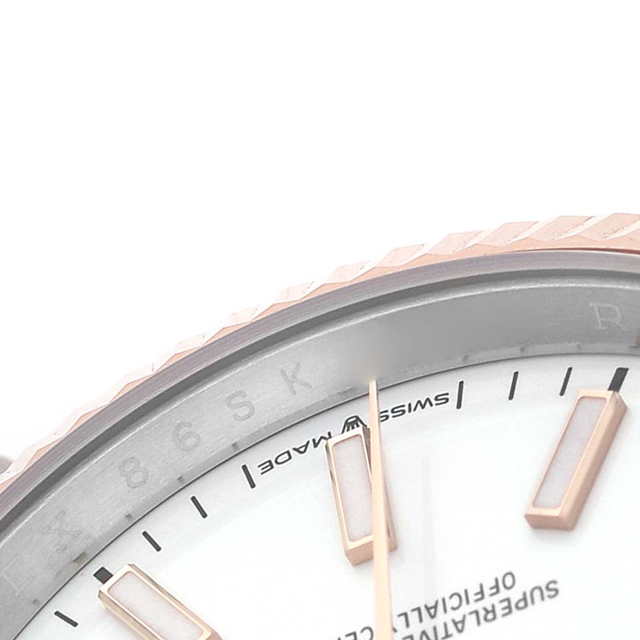 The image shows a close-up of the dial and bezel edge of a Rolex Datejust 126231 Men's Steel and Gold (two tone) White Dial watch, highlighting the hour markers and "Swiss Made" text.