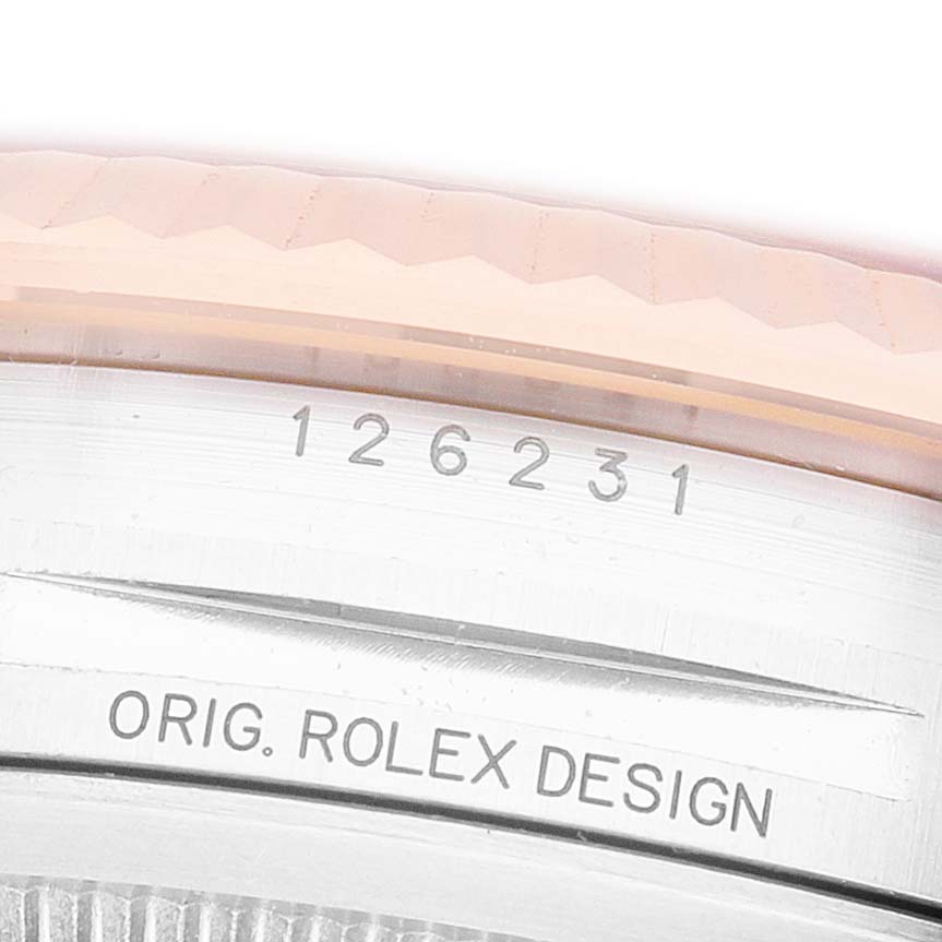 The image shows a close-up of the Rolex Datejust 126231 Men's Steel and Gold (two tone) White Dial model's side, featuring the bezel with engraved text.