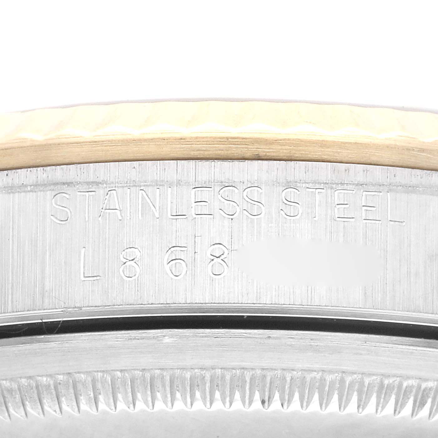 This image shows a close-up of the side engraving on a Rolex Datejust 16233 Men's Steel and Gold (two tone) Black Dial 16233 Men's Steel and Gold (two tone) Black Dial model, highlighting "Stainless Steel" text.