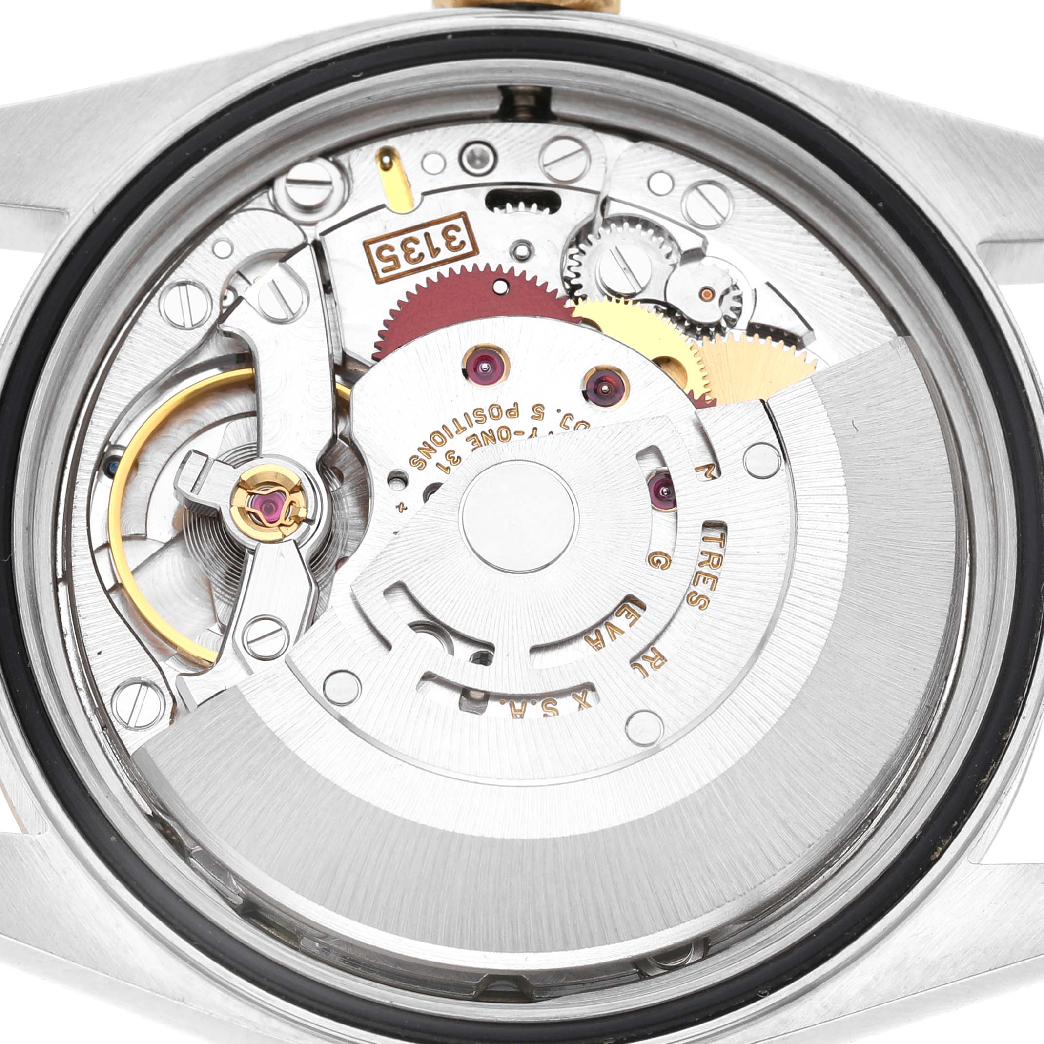 The image shows the back of a Rolex Datejust 16233 Men's Steel and Gold (two tone) Champagne Dial watch, highlighting its intricate mechanical movement and gears.