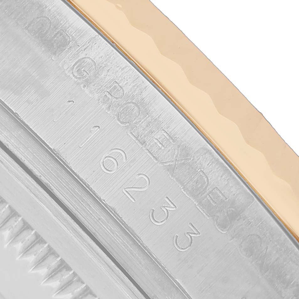 The image shows a close-up of the case side with engravings on a Rolex Datejust 116233 Men's Steel and Gold (two tone) White Dial watch.
